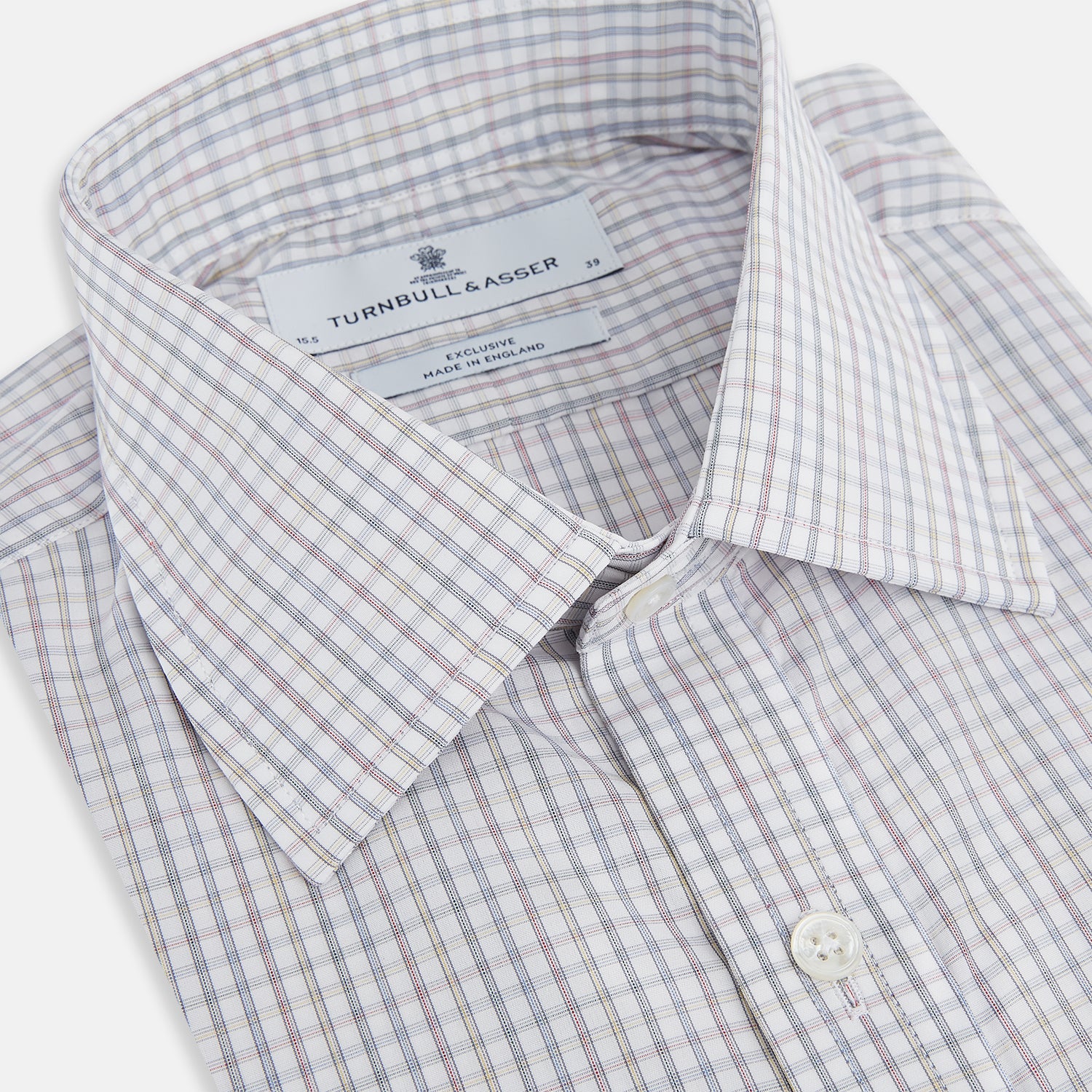 Image 2 of product The Turnbull & Asser Sky Blue Multi Graph Check Shirt features long sleeves, a button-up front, pointed T&A collar, buttoned cuffs, and a small blue-and-white check pattern, shown on a white background.