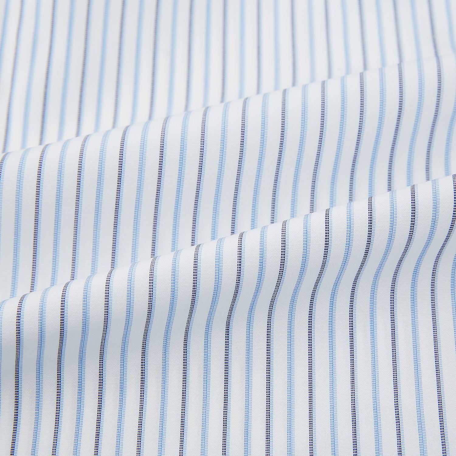 Image 6 of product The Turnbull & Asser Navy and Blue Shadow Stripe Mayfair Shirt, featuring a classic T&A collar and buttoned cuffs, is laid flat on a white background.