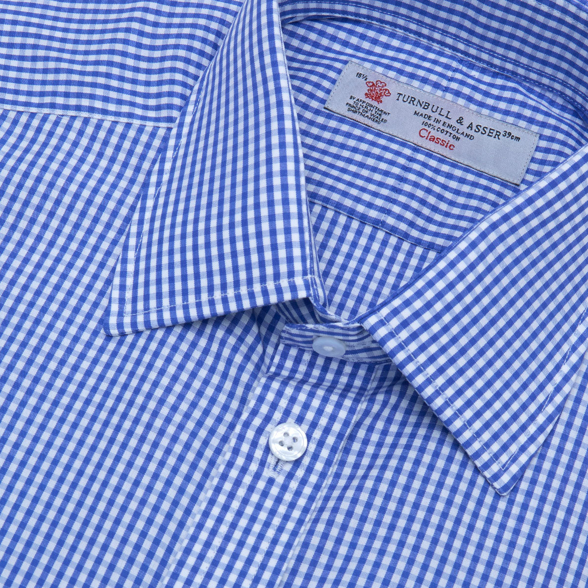 Image 2 of product The Turnbull & Asser Mid-Blue Gingham Check Shirt features a T&A collar and 3-button cuffs, crafted from cotton and displayed folded on a plain white background.