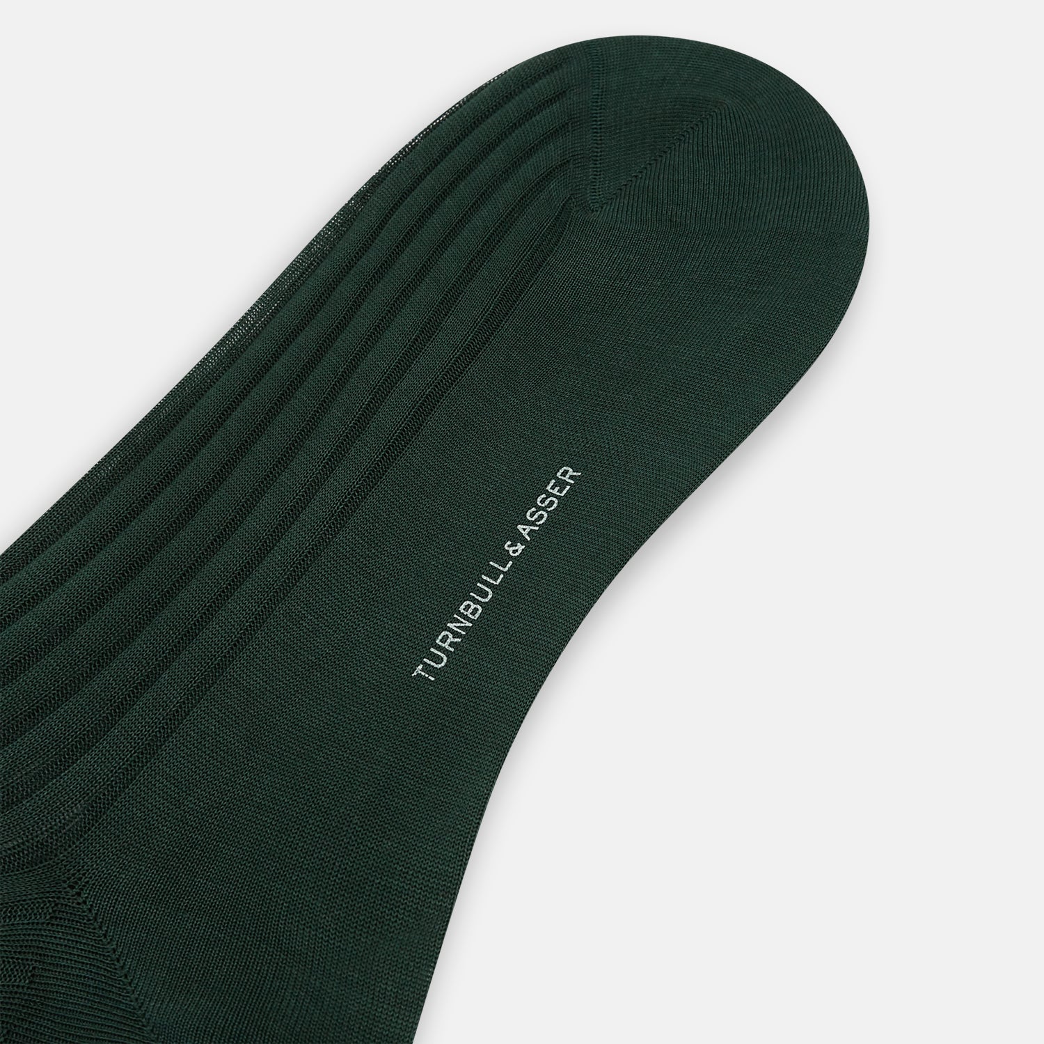 Image 3 of product Turnbull & Asser's Olive Mid-Length Socks, crafted from mercerised Egyptian cotton in dark green with ribbed detailing, are displayed against a plain white background, showcasing refined comfort and enduring style.