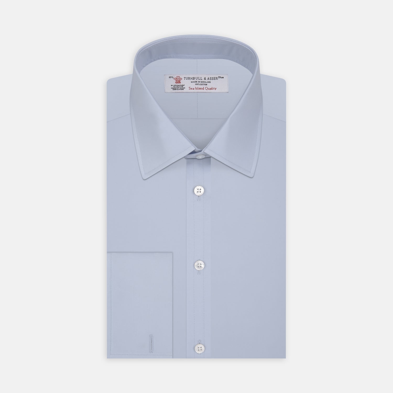 Image 1 of product The Turnbull & Asser Light Blue Sea Island Quality Cotton Shirt features a T&A collar, double cuffs, white buttons, and a quality label inside the collar. Displayed on a plain white background.