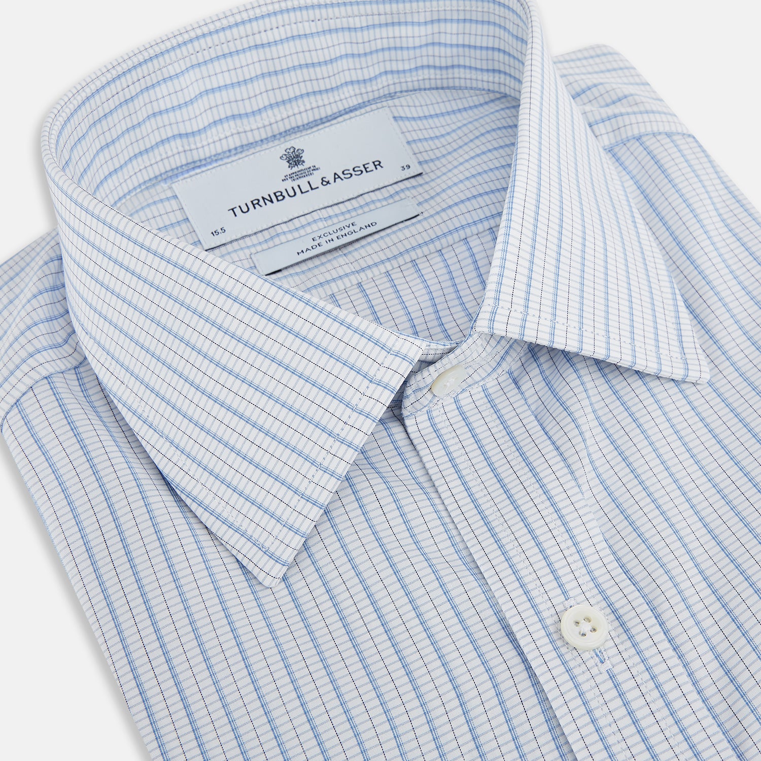 Image 2 of product The Turnbull & Asser Blue Graph Check Mayfair Shirt features a classic T&A collar, Mayfair fit, buttoned cuffs, and long sleeves with light blue graph checks on a white background.