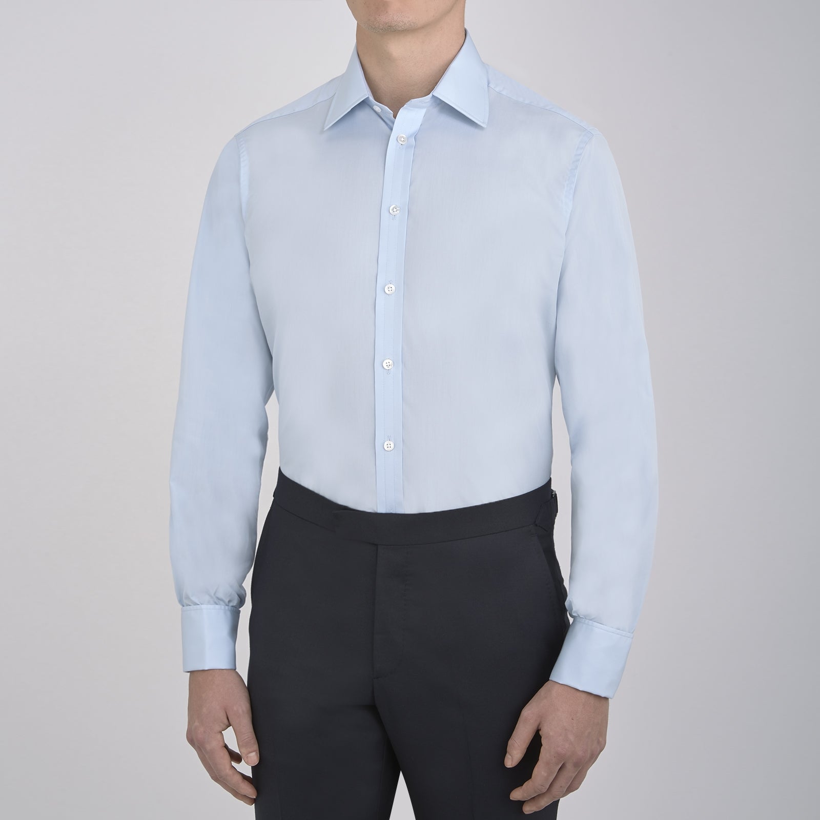Image 5 of product The Turnbull & Asser Light Blue Sea Island Quality Cotton Shirt features a T&A collar, double cuffs, white buttons, and a quality label inside the collar. Displayed on a plain white background.