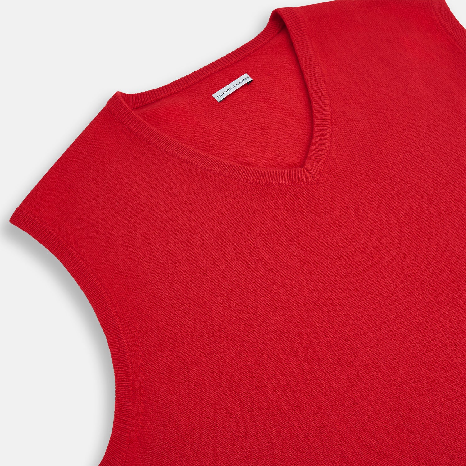 Image 2 of product The Turnbull & Asser Red Cashmere V-Neck Vest features a sleeveless knit design and classic collar, shown against a white background—ideal for elevating any refined look.