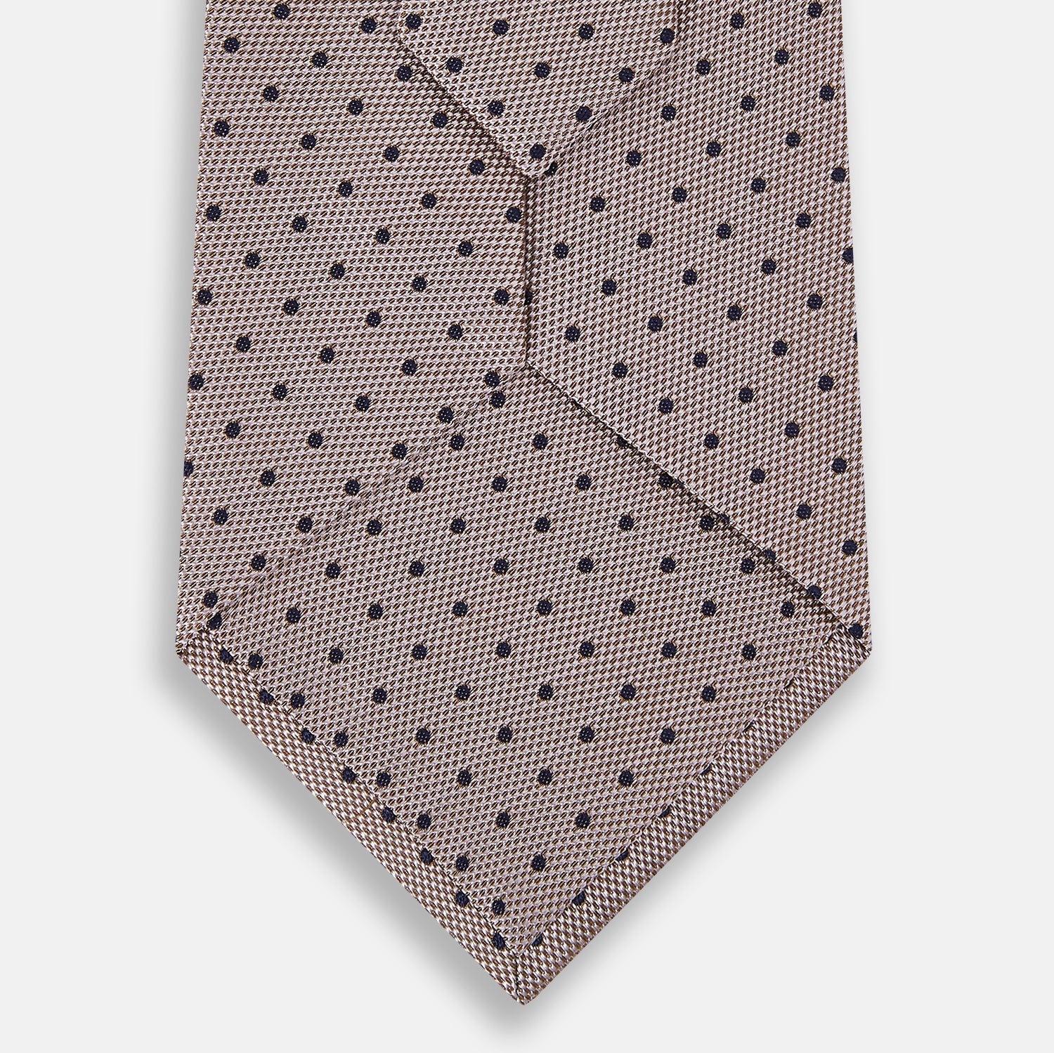Image 3 of product The Turnbull & Asser Navy and Lilac Micro Dot Silk Tie, featuring subtle micro dots, is the perfect refined accessory for smart outfits, shown rolled up against a plain white background.