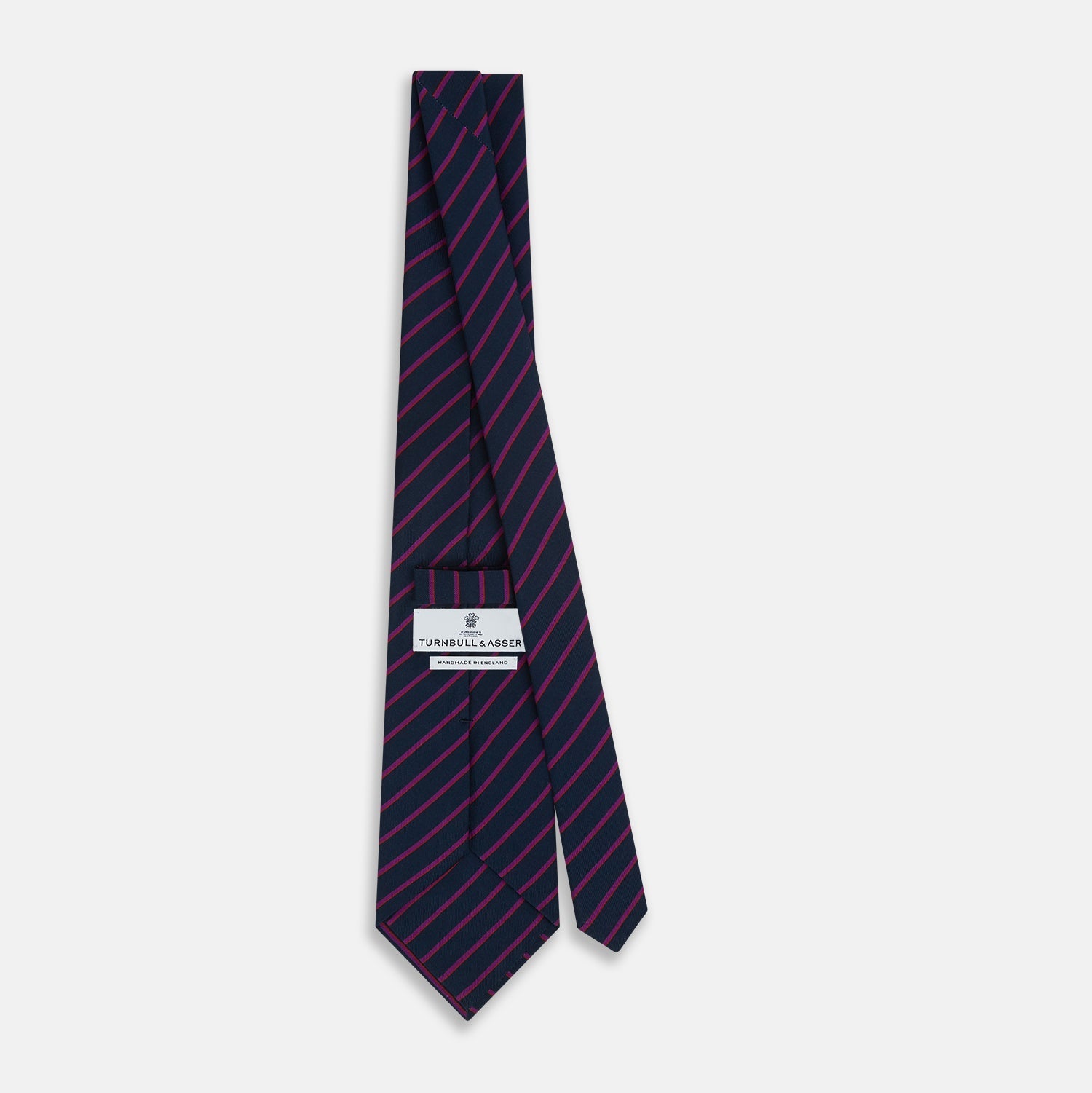 Image 4 of product The Turnbull & Asser Navy and Purple Striped Blazer Silk Tie features British craftsmanship with diagonal magenta and purple stripes, displayed neatly rolled on a white background.