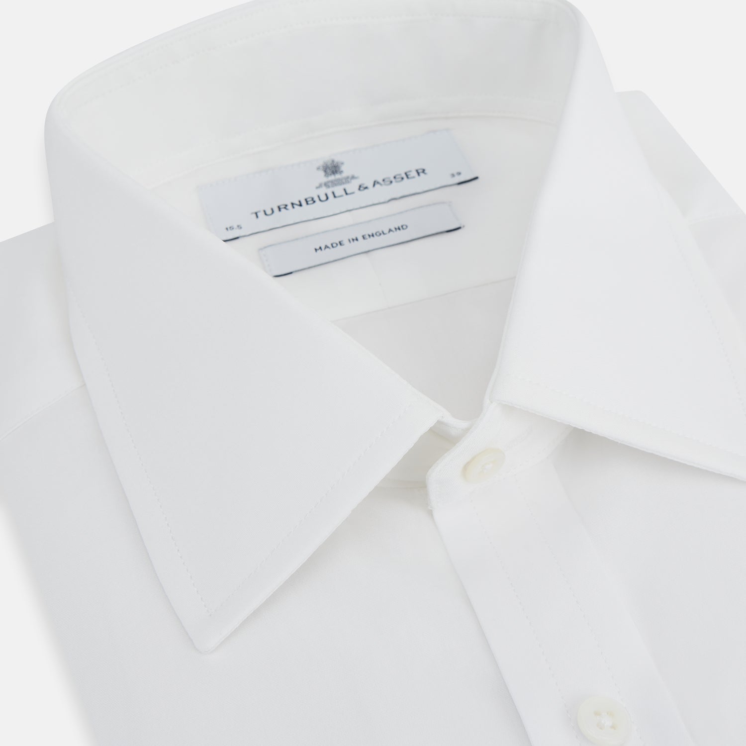 Image 2 of product The Turnbull & Asser Plain White Cotton Shirt features a T&A collar and double cuffs, shown flat on a white background—ideal for pairing with standout ties or achieving a minimalist look.