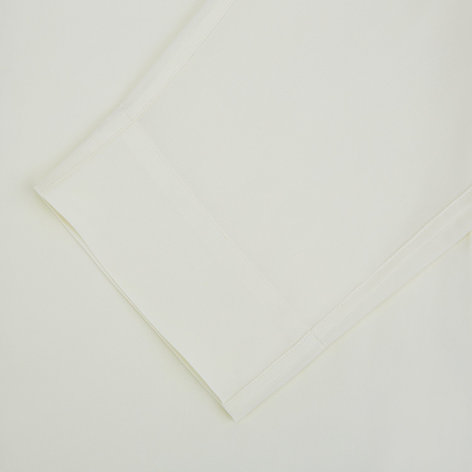 Image 3 of product The Turnbull & Asser Cream Silk Pyjama Set, shown laid flat on a white background, features a long-sleeve button-up top with a chest pocket and matching pants with an elastic drawstring waist—ideal for comfortable loungewear.
