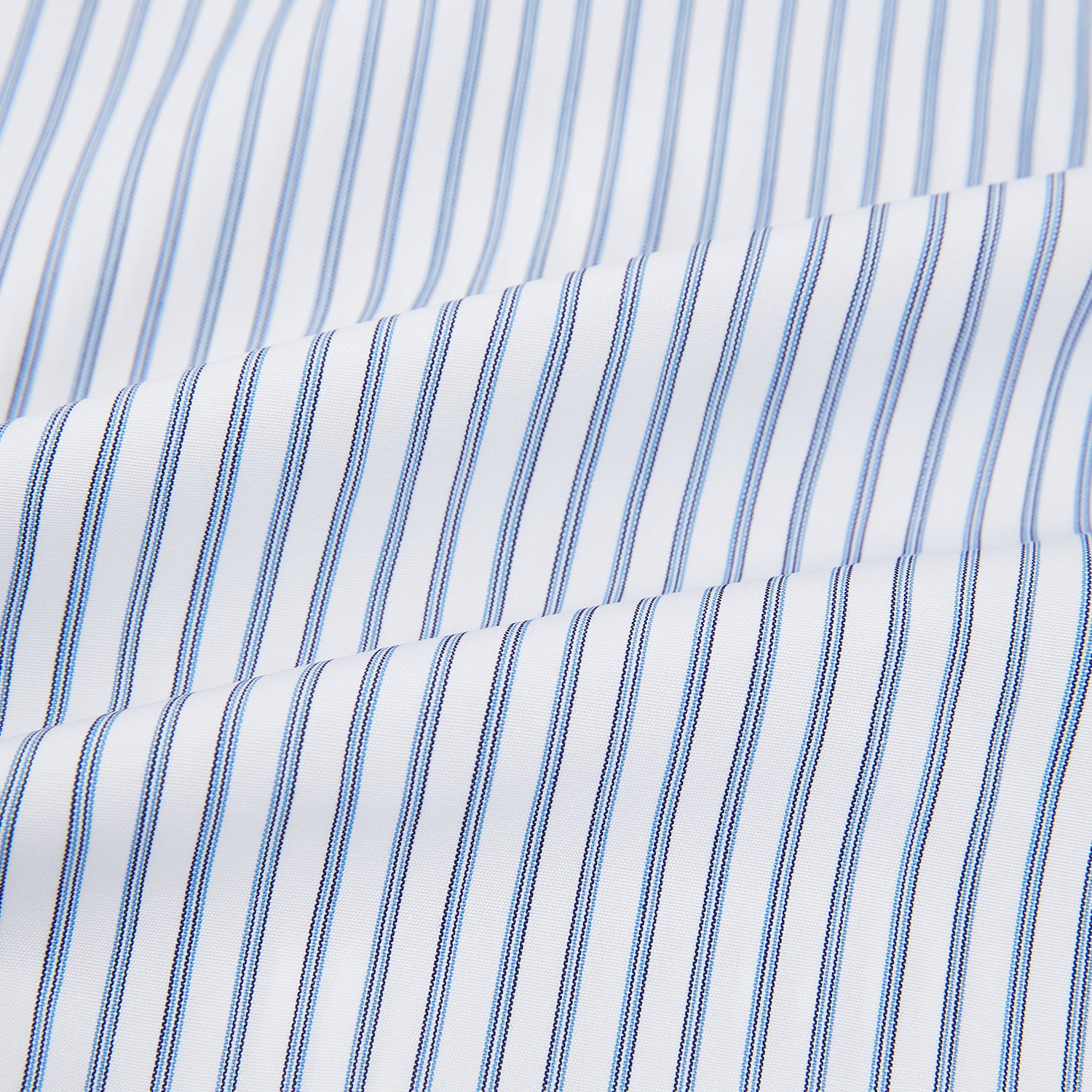 Image 6 of product The Turnbull & Asser Navy Double Pinstripe Mayfair Shirt is a long-sleeve, button-up collared shirt with thin vertical blue and white stripes, shown against a plain white background.