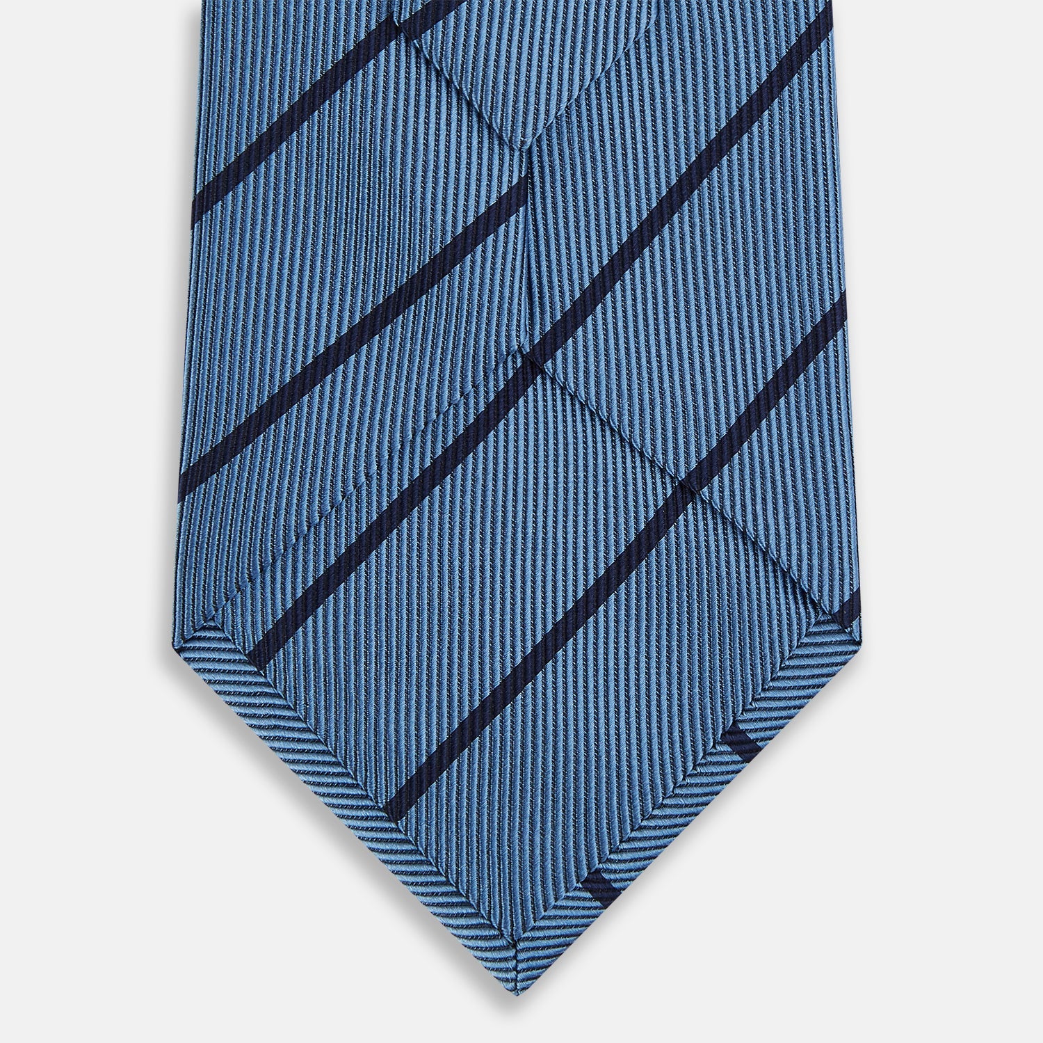 Image 3 of product The Turnbull & Asser Blue and Navy Blazer Stripe Silk Tie features diagonal navy stripes and is shown rolled up against a plain white background.