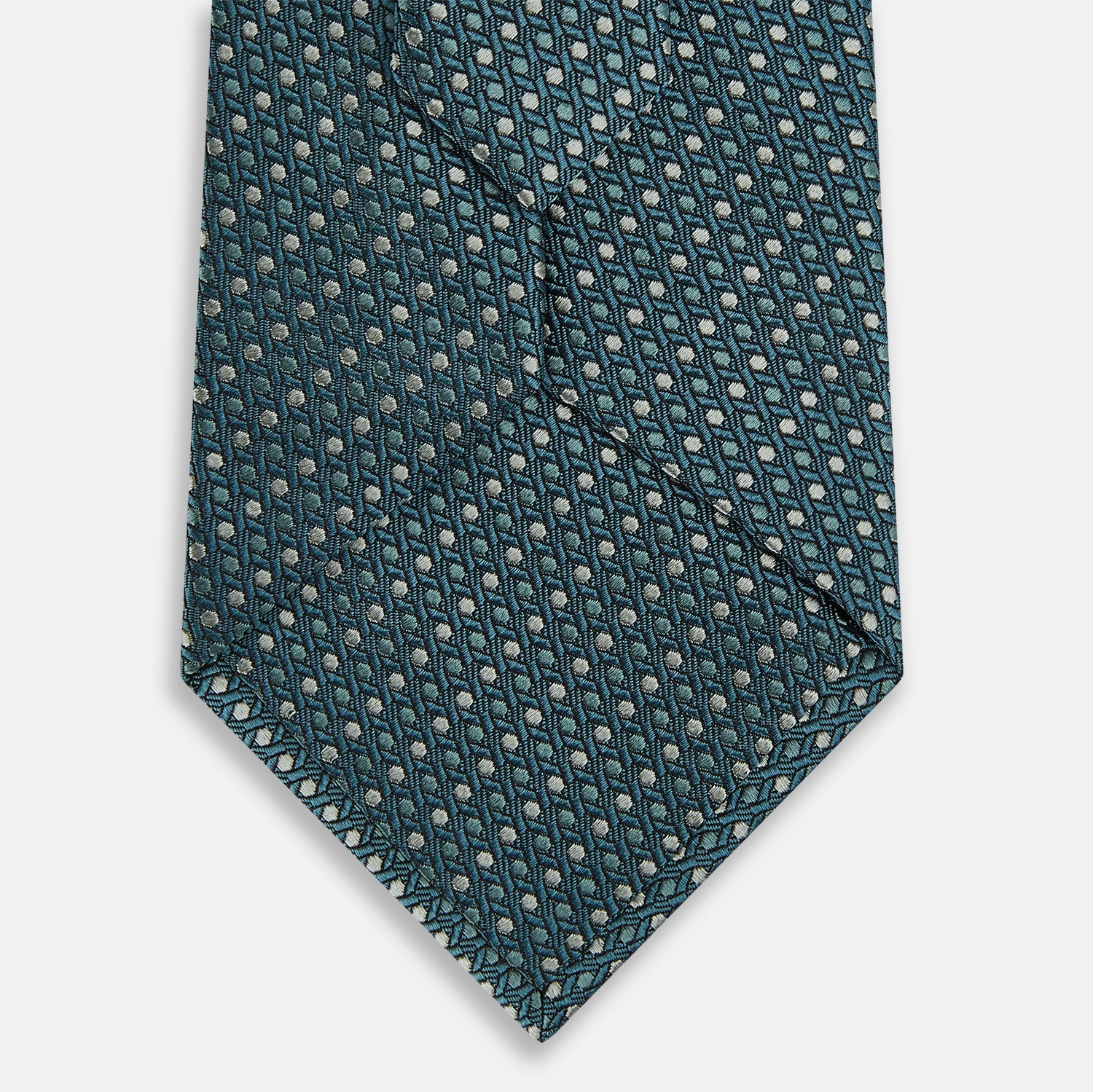 Image 3 of product The Turnbull & Asser Teal Micro Hexagon Silk Tie showcases a textured geometric dot and subtle hexagon pattern, adding a refined touch to any tailored look.