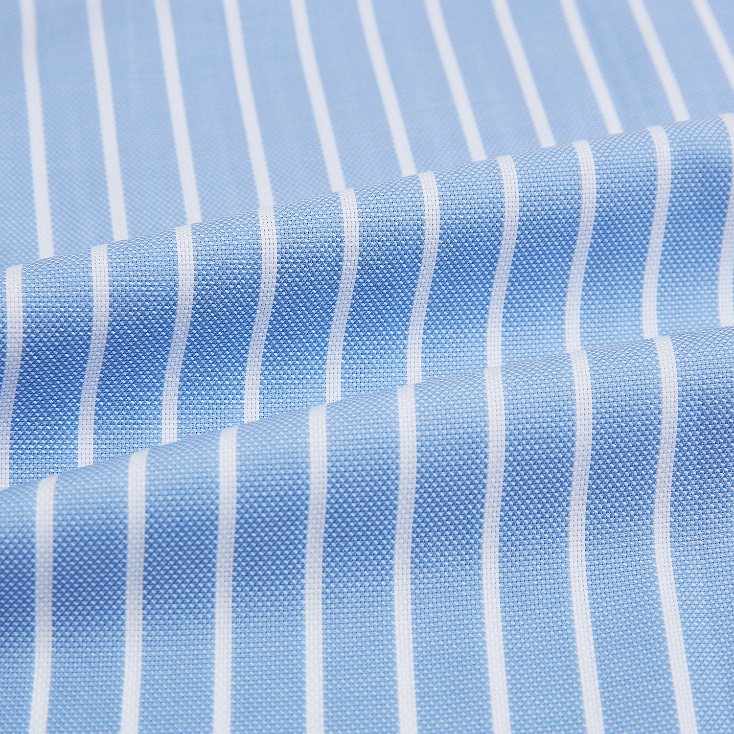 Image 6 of product The Turnbull & Asser Sky Blue Wide Pinstripe Mayfair Shirt features long sleeves, a classic collar, and buttoned cuffs, laid flat against a white background for a refined formal look.