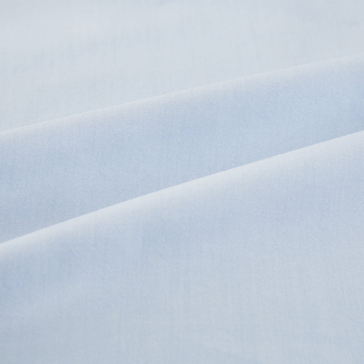 Image 6 of product The Pale Blue Mayfair Shirt by Turnbull & Asser is a long-sleeve, button-up dress shirt with a pointed collar and buttoned cuffs, crafted from sanforised cotton and shown laid flat on a white background.