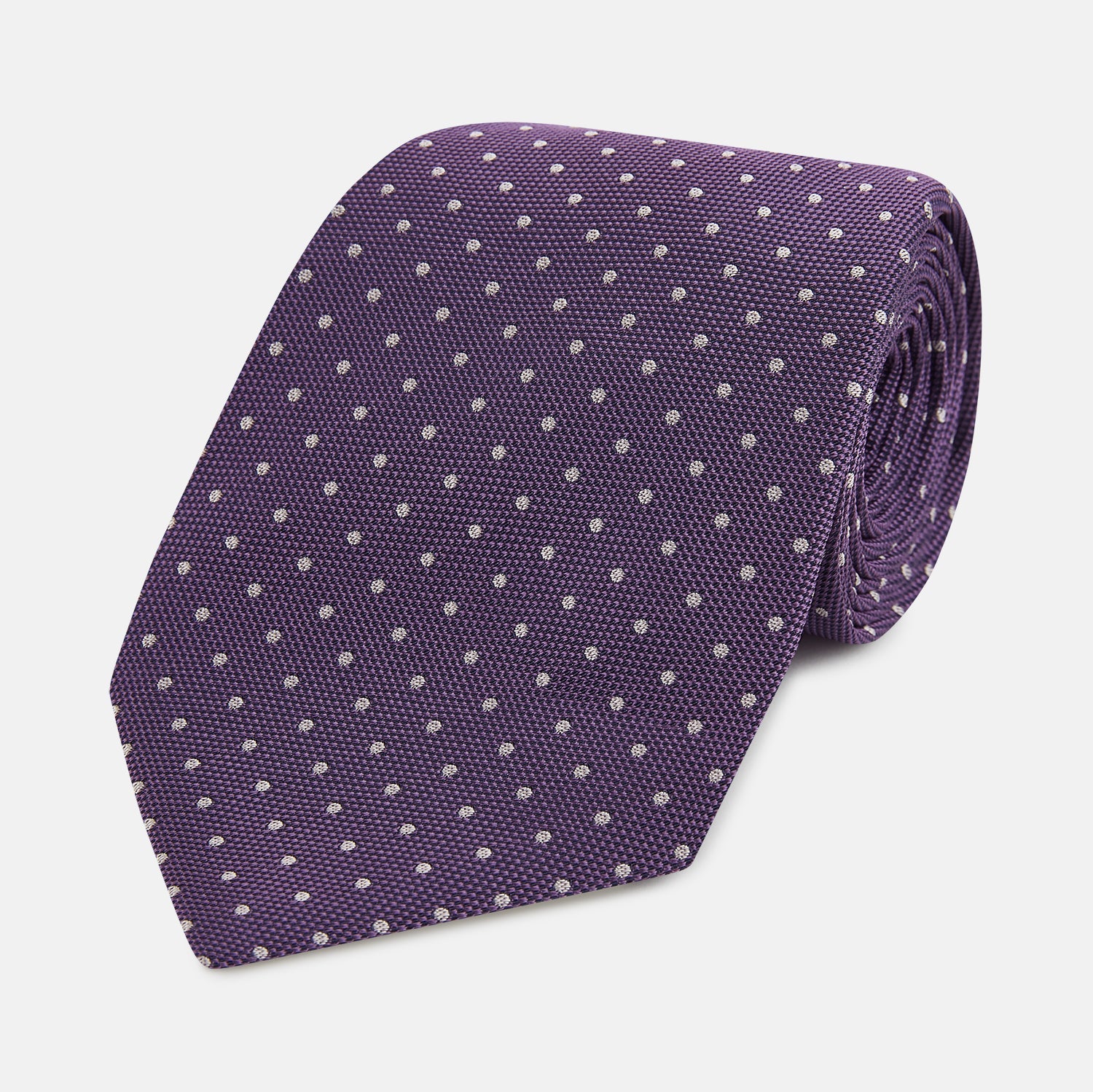 Image 1 of product The Turnbull & Asser Lavender and Purple Micro Dot Silk Tie is displayed rolled-up against a plain white background.