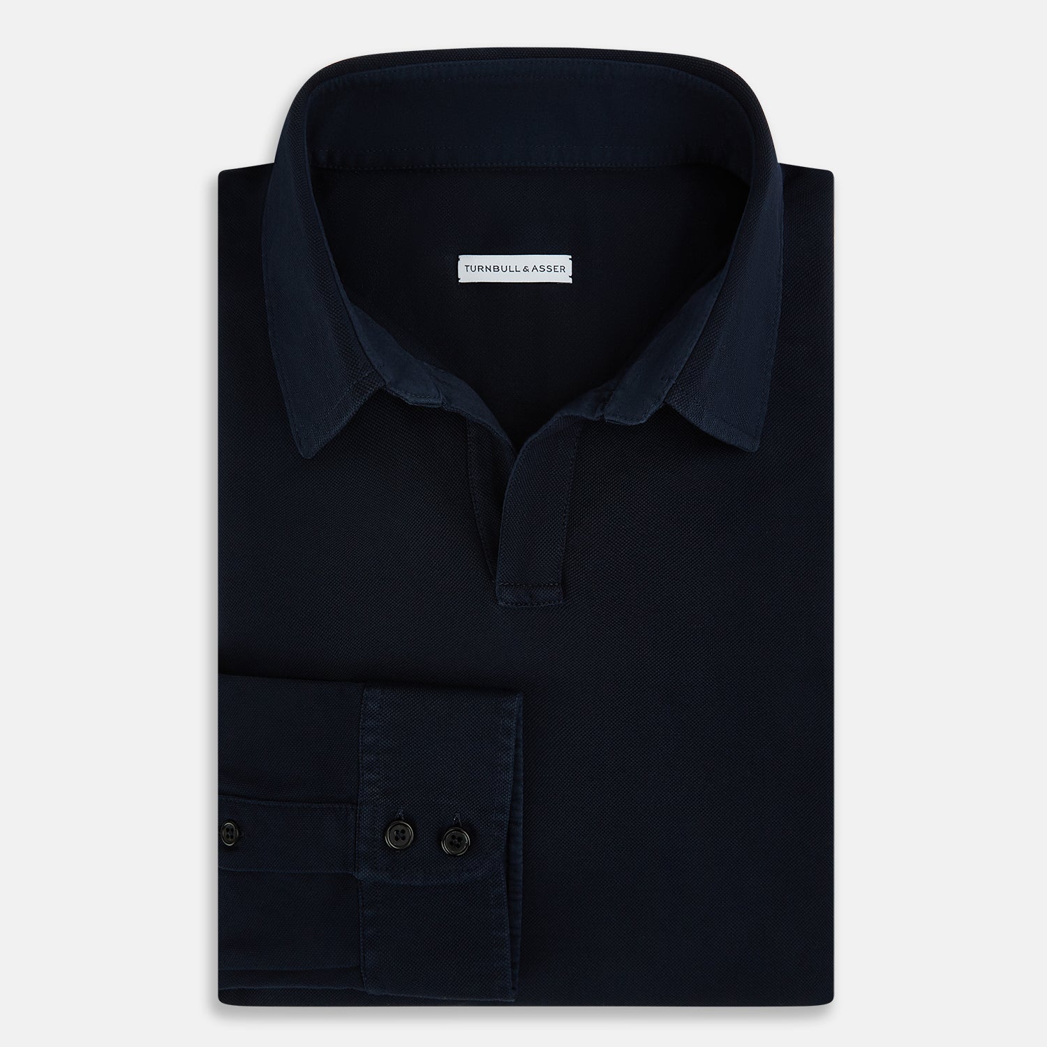 Image 5 of product A Navy Rugby Polo Shirt by Turnbull & Asser, featuring long sleeves and a collar, is displayed flat on a white background. The design is simple and free of visible logos or patterns.