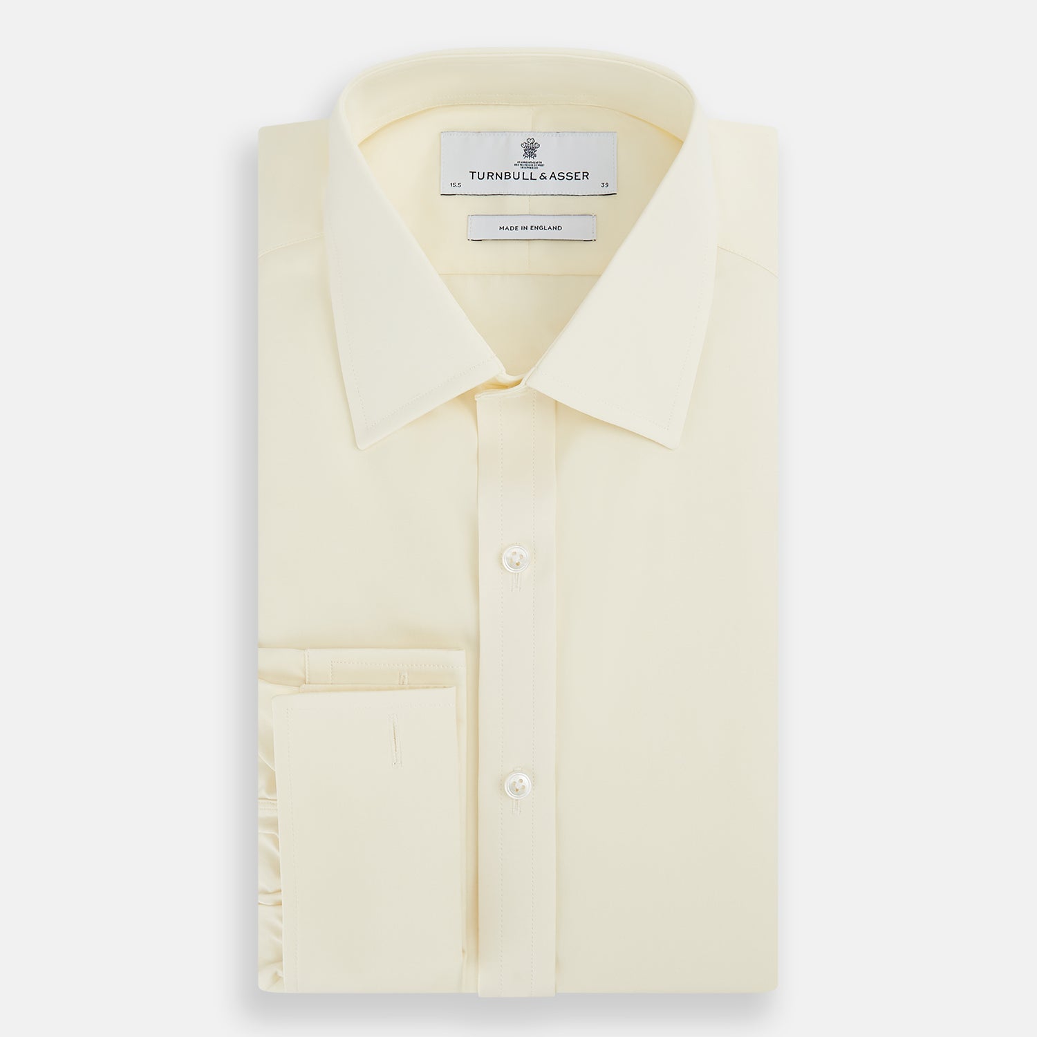 Image 5 of product The Turnbull & Asser Cream Cotton Shirt features a T&A collar and double cuffs, elevating men's style. Displayed flat against a white background, this long-sleeve shirt is crafted in classic cream cotton.
