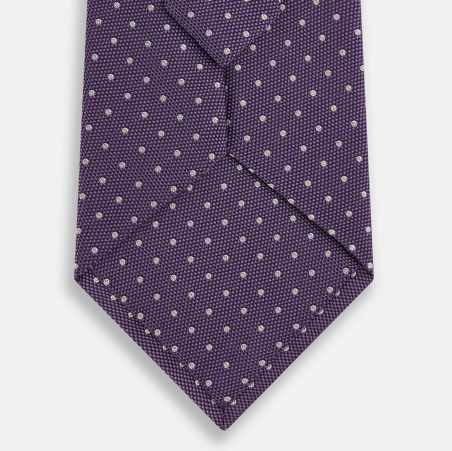 Image 3 of product The Turnbull & Asser Lavender and Purple Micro Dot Silk Tie is displayed rolled-up against a plain white background.