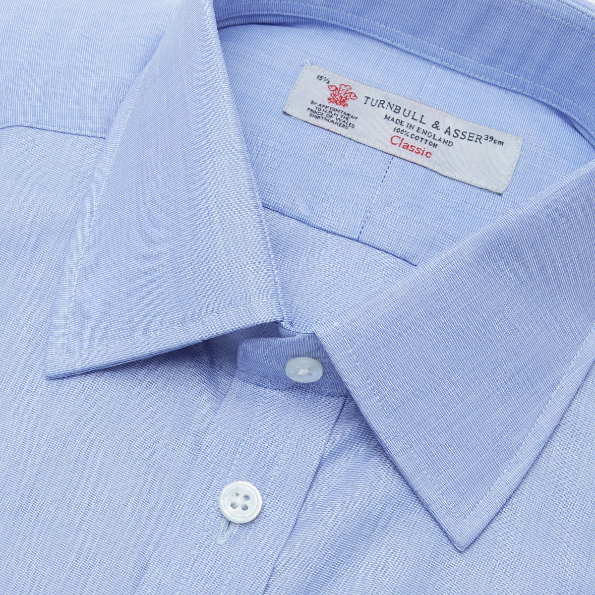 Image 2 of product The Turnbull & Asser Blue End-on-End Cotton Shirt features a T&A collar, double cuffs, and white buttons—ideal for smart looks or pairing with a navy suit. Displayed against a plain white background.