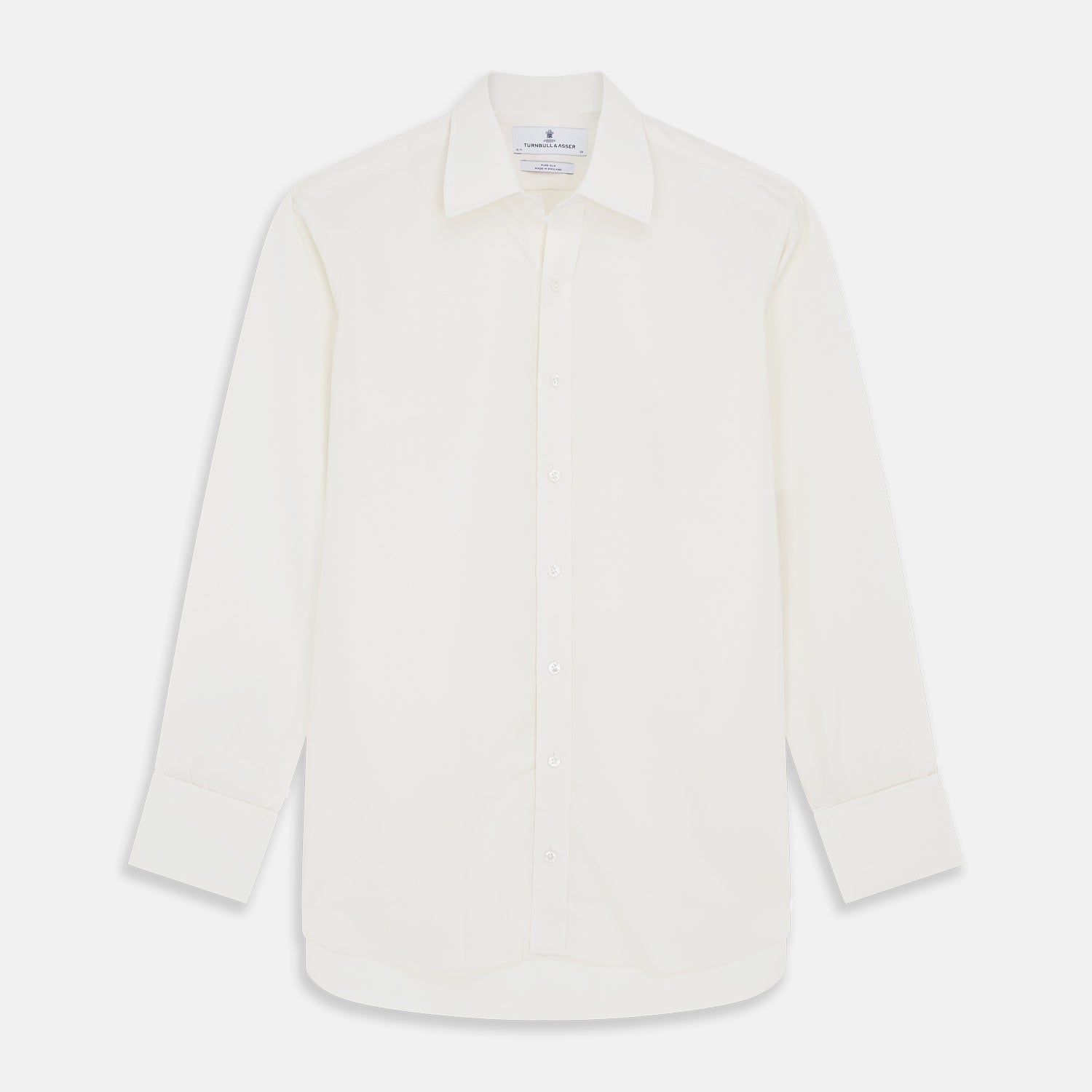 Image 1 of product The Cream Silk Whitby Shirt by Turnbull & Asser features a pointed collar, buttoned front and cuffs, and long sleeves, shown in Whitby Fit and laid flat on a white background.