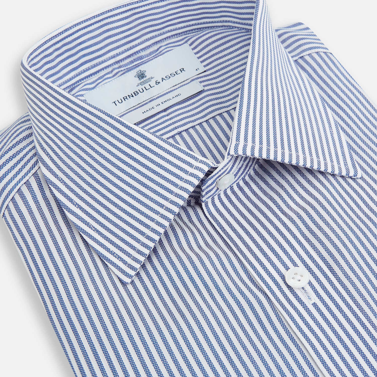 Image 2 of product The Turnbull & Asser Navy Bengal Stripe Mayfair Shirt is a long-sleeved, collared formal shirt with blue and white stripes, white buttons, and buttoned cuffs—ideal for classic style enthusiasts. Displayed on a plain white background.