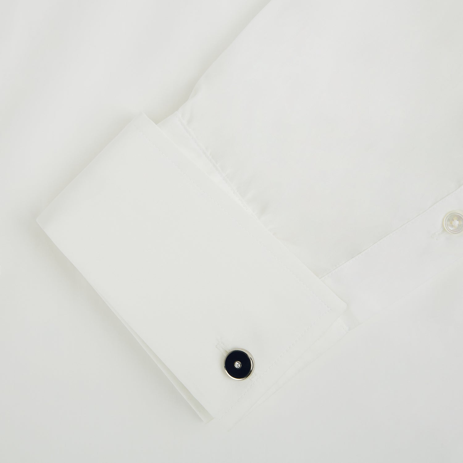 Image 3 of product Turnbull & Asser's Navy Gemstone Circle Cufflinks feature round sterling silver with black enamel centers and a clear gemstone, shown on a white background.