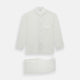 The Turnbull & Asser Cream Silk Pyjama Set, shown laid flat on a white background, features a long-sleeve button-up top with a chest pocket and matching pants with an elastic drawstring waist—ideal for comfortable loungewear.