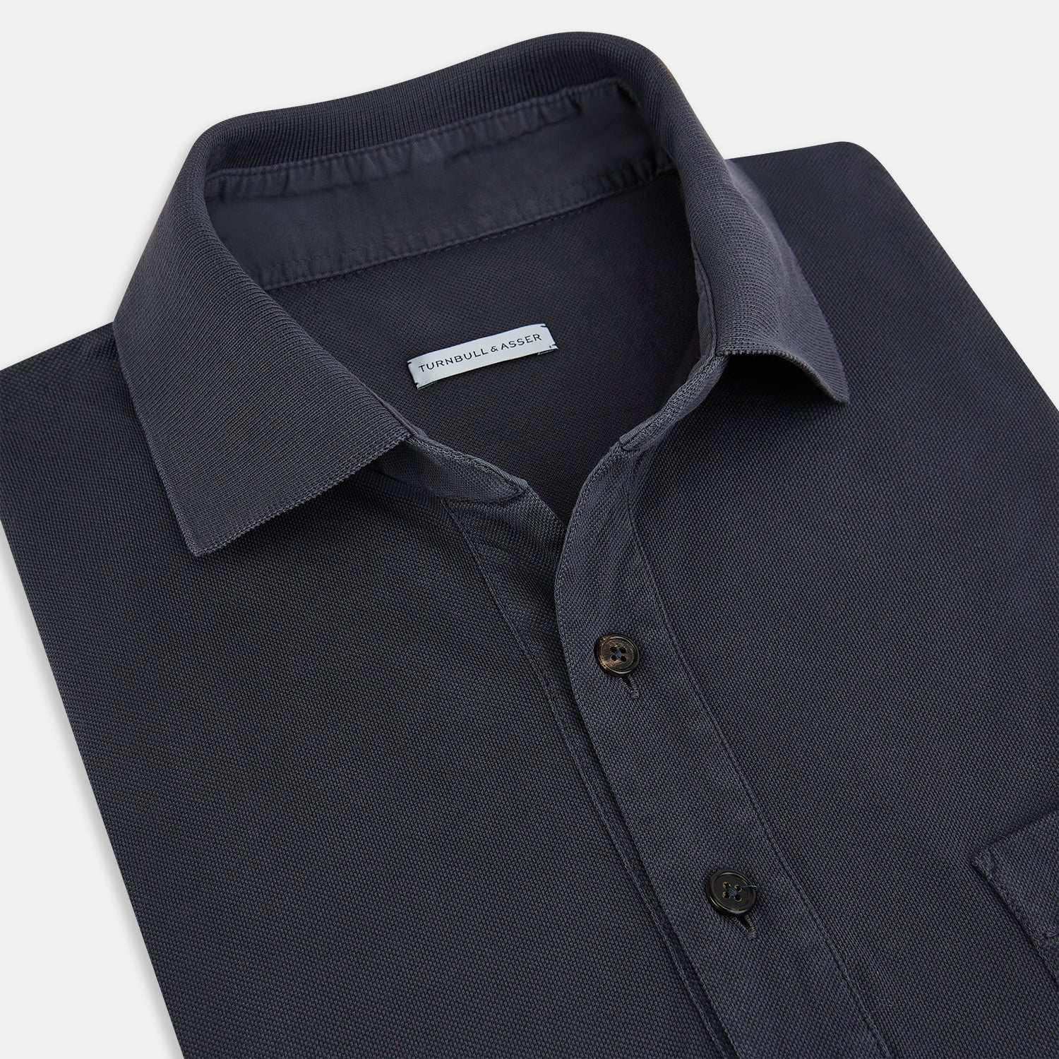 Image 2 of product The Turnbull & Asser Charcoal Polo Shirt is a short-sleeve, soft cotton jersey top with a collar, three-button placket, and a left chest pocket, shown on a plain white background.
