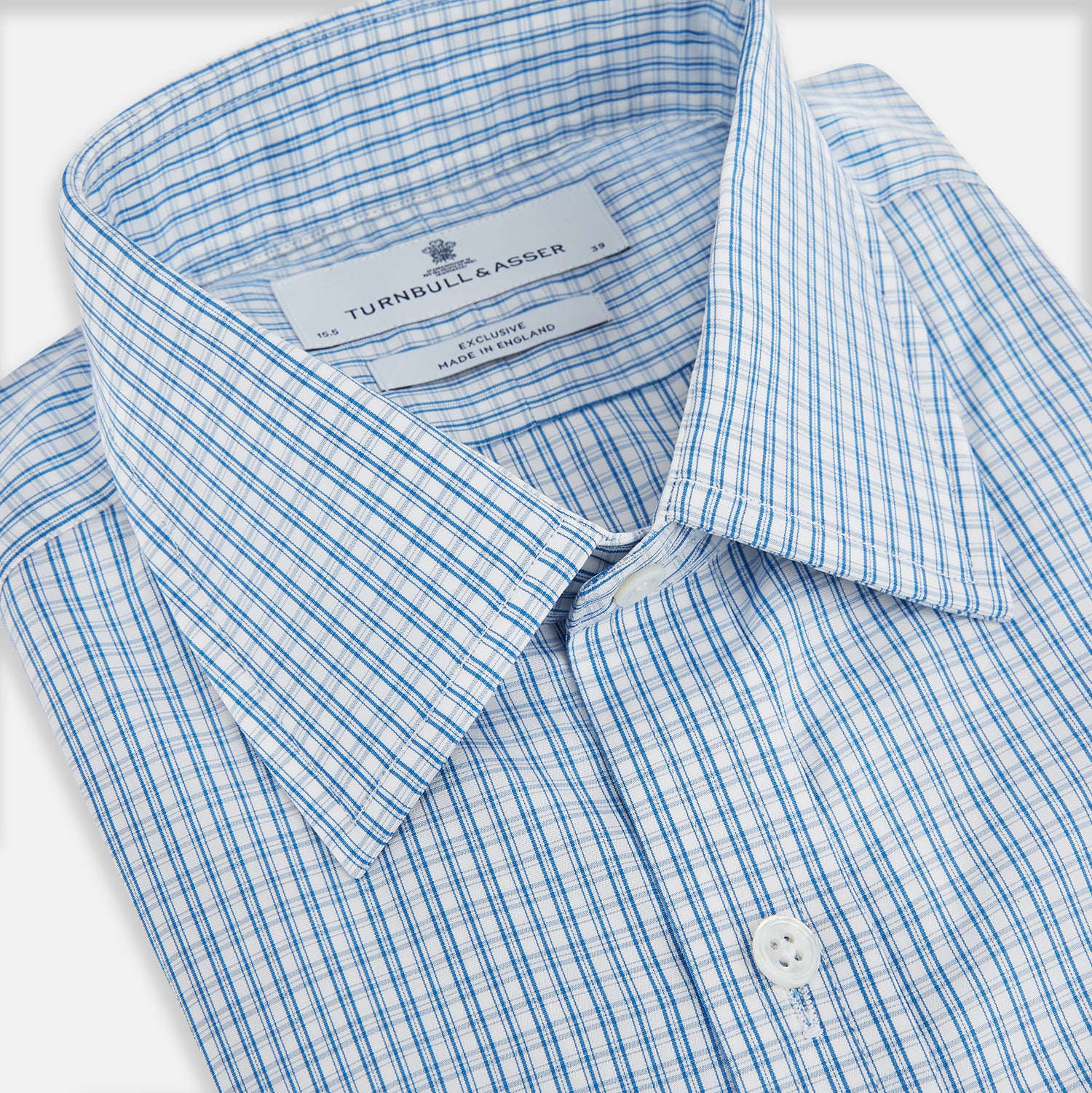 Image 2 of product The Sky Blue Micro Graph Check Mayfair Shirt by Turnbull & Asser features a classic T&A collar, button-down front, and buttoned cuffs, shown laid flat on a white background.
