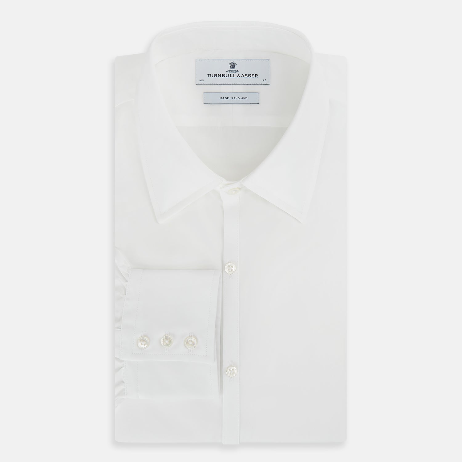 Image 5 of product The PLAIN WHITE WESTMINSTER SHIRT WITH TURNBULL COLLAR AND 3-BUTTON CUFFS by Turnbull & Asser features refined British craftsmanship, long sleeves, a straight hem, and a crisp white design displayed on a plain background.