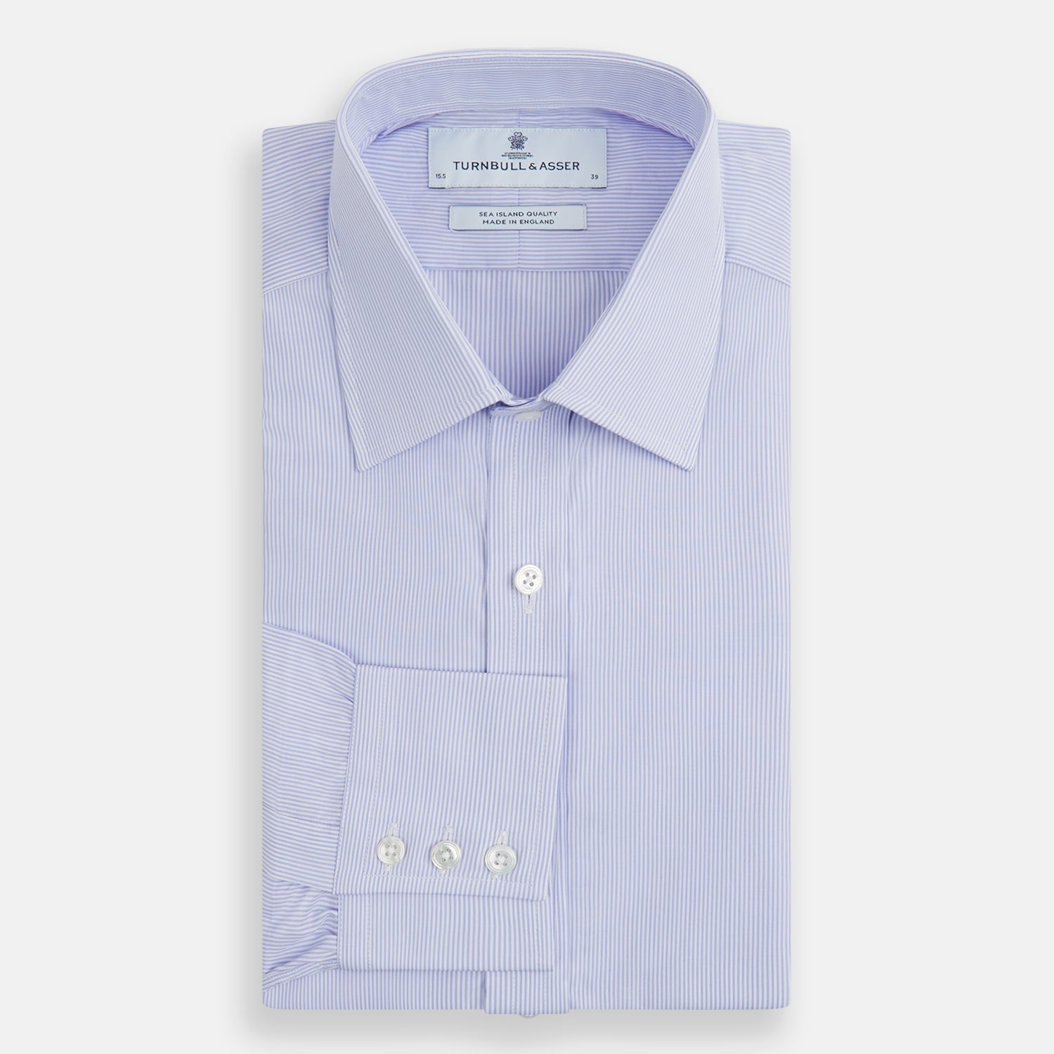 Image 5 of product A Blue and White Fine Bengal Stripe Sea Island Quality Cotton Shirt by Turnbull & Asser, featuring a T&A collar and 3-button cuffs, is laid flat on a white background.