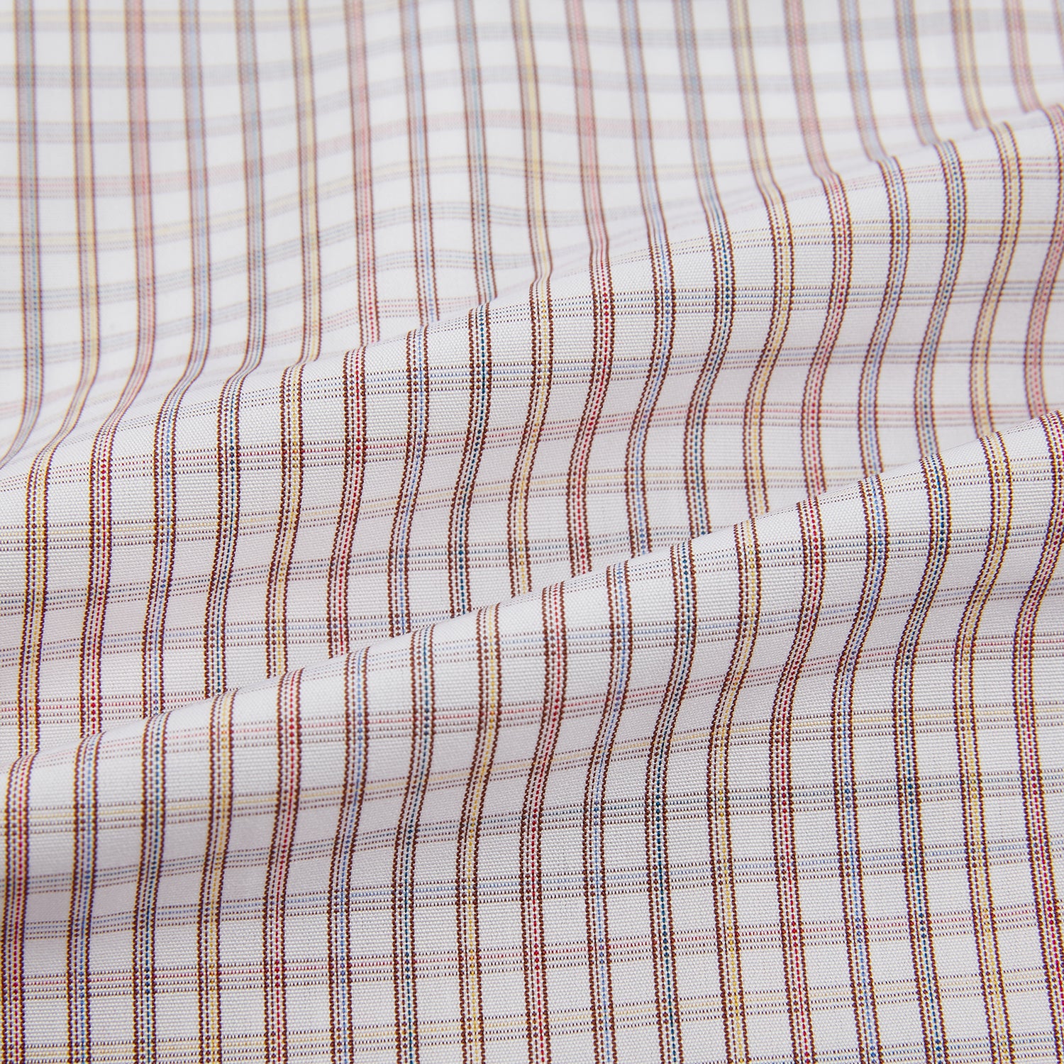 Image 6 of product The Turnbull & Asser Multicoloured Check Mayfair Shirt is a long-sleeve, button-up shirt with a classic collar and buttoned cuffs, showcasing a true British checkered pattern on a white background.