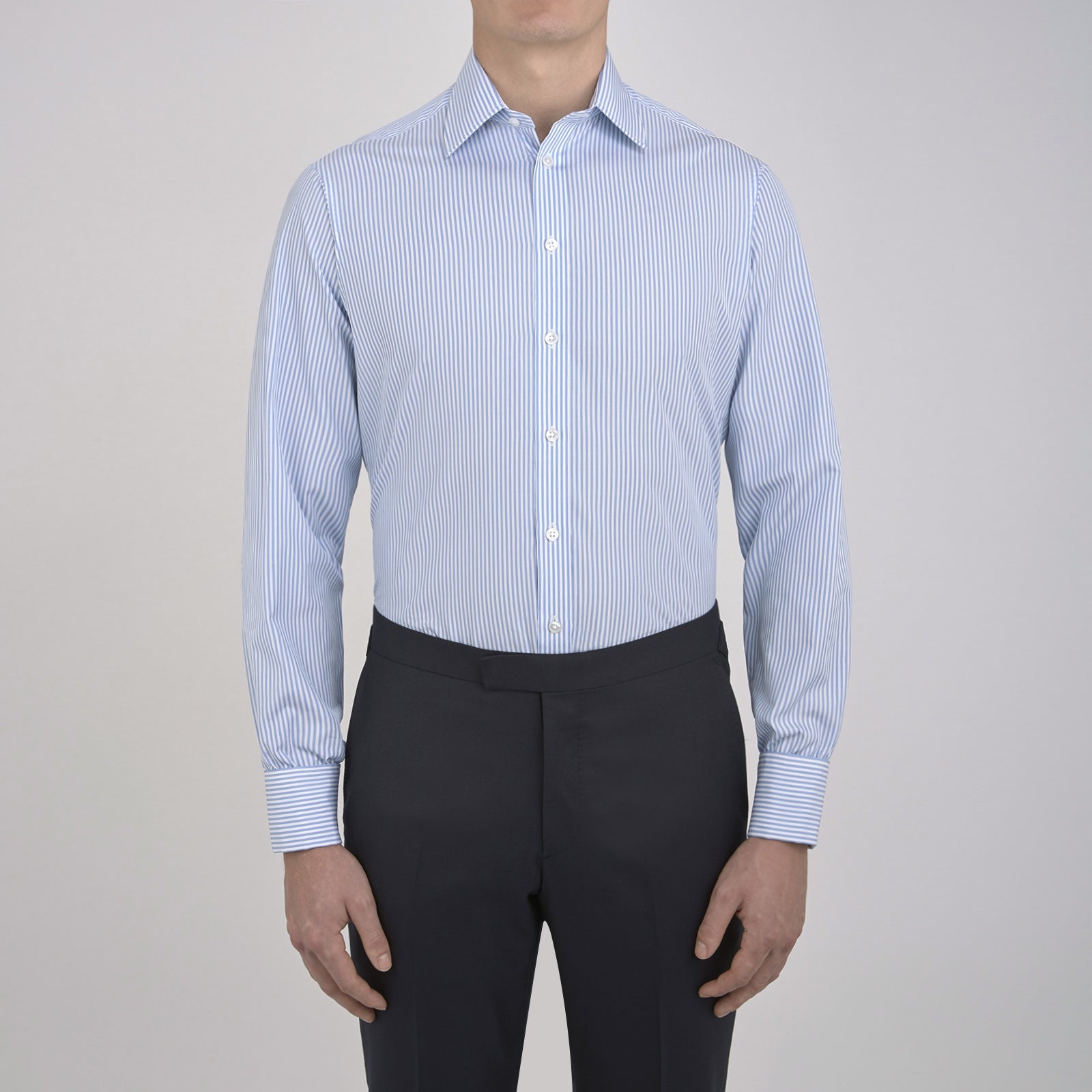 Image 5 of product The Turnbull & Asser Light Blue Bengal Stripe Shirt features a classic T&A collar, double cuffs, and white buttons. Made from cotton with blue and white stripes, it's neatly displayed against a plain white background.