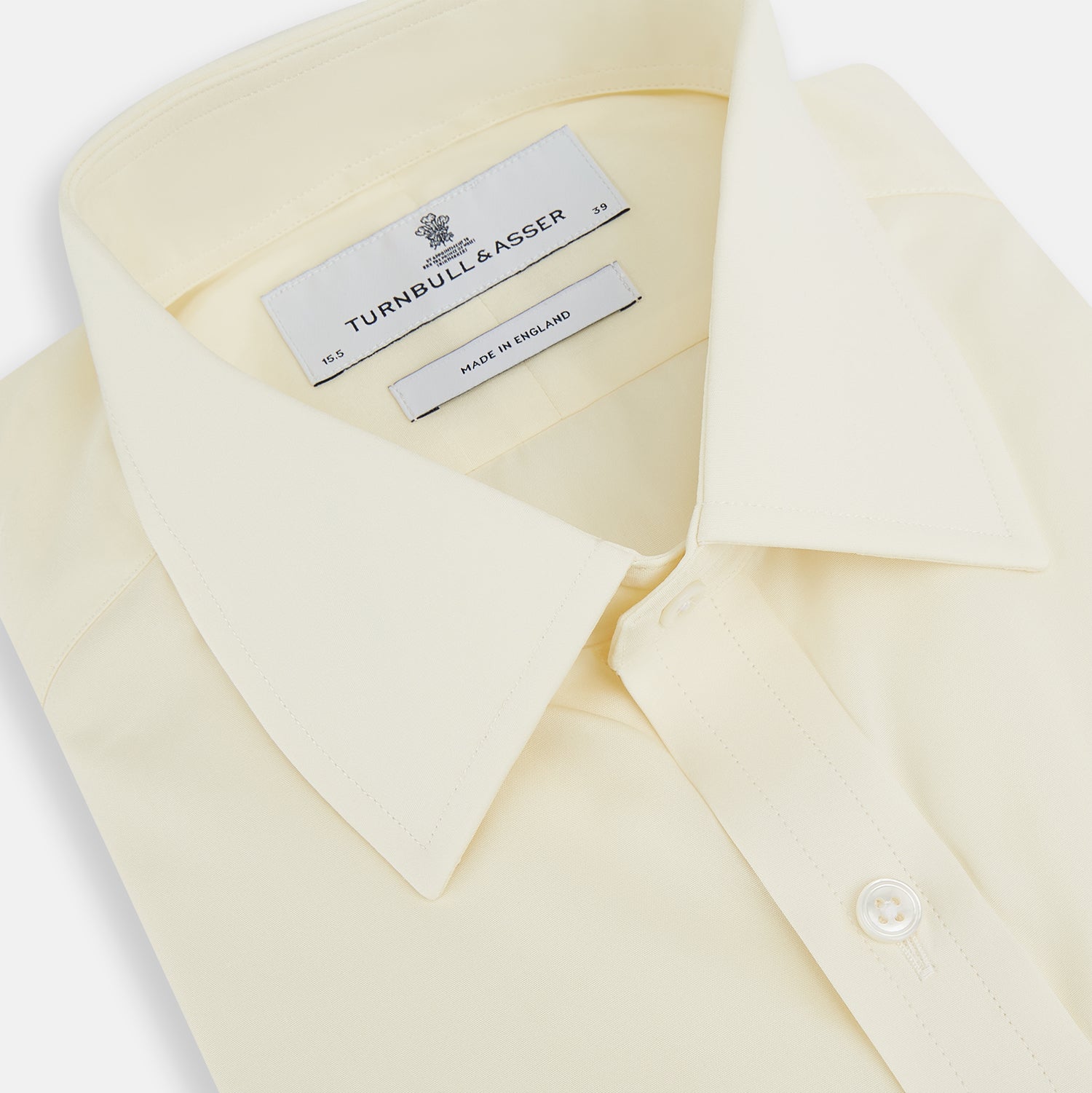 Image 2 of product The Turnbull & Asser Cream Cotton Shirt features a T&A collar and double cuffs, elevating men's style. Displayed flat against a white background, this long-sleeve shirt is crafted in classic cream cotton.