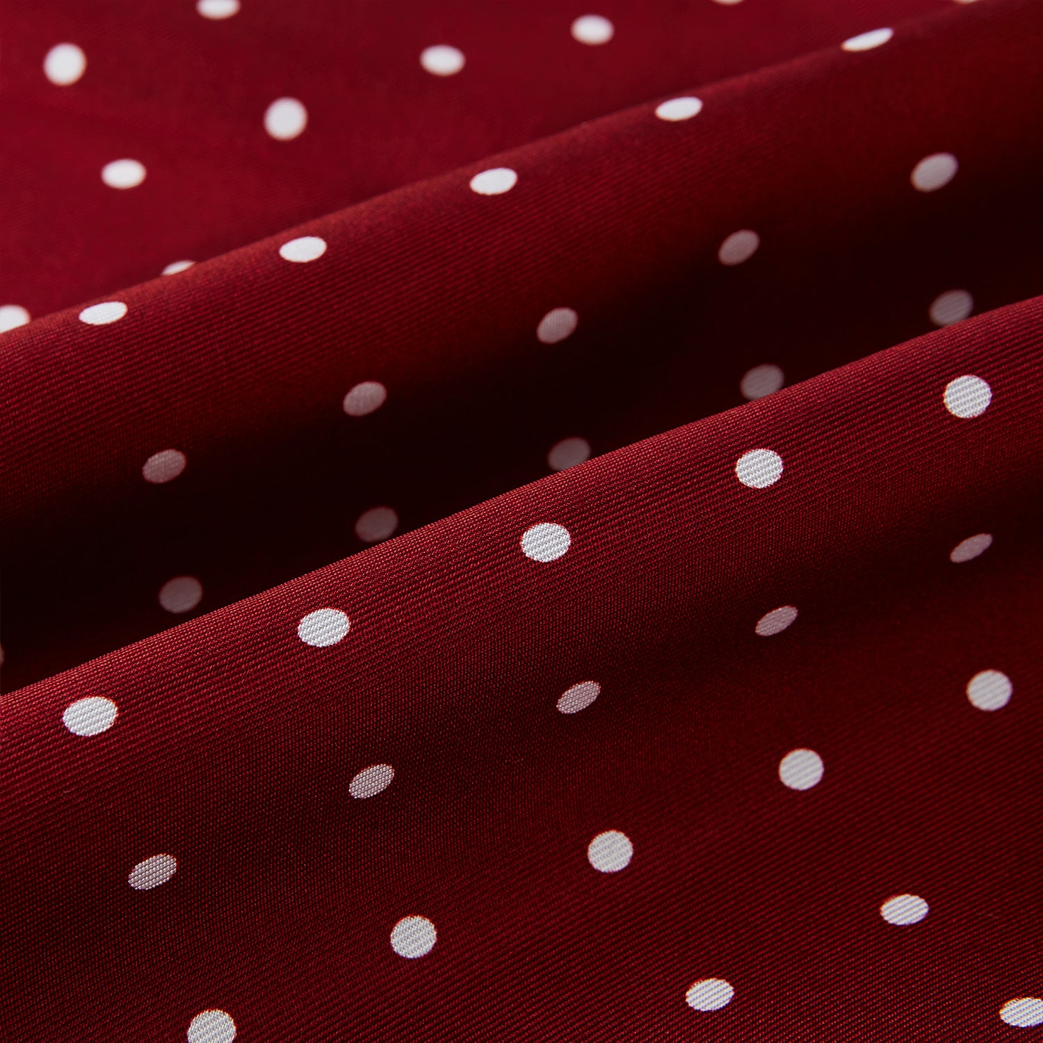 Image 3 of product The Burgundy and White Spotted Silk Scarf by Turnbull & Asser features a gradient of white polka dots, short fringed edges, and the brand's name near the ends—a timeless classic foulard.