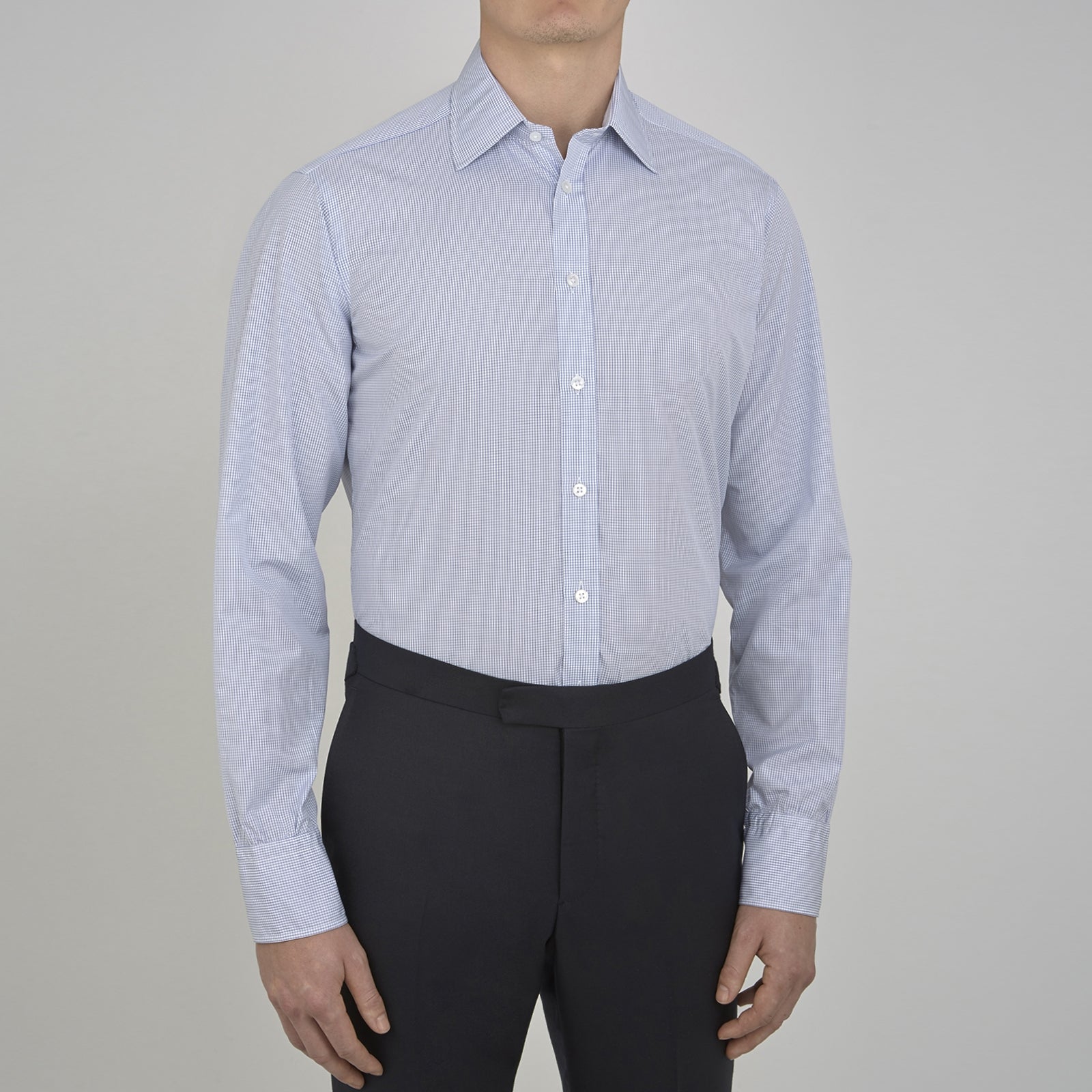Image 4 of product A neatly folded Turnbull & Asser Blue Grid Check Shirt features a T&A collar, 3-button cuffs, white buttons, and subtle British style. The blue and white check cotton design displays the brand label inside the collar.