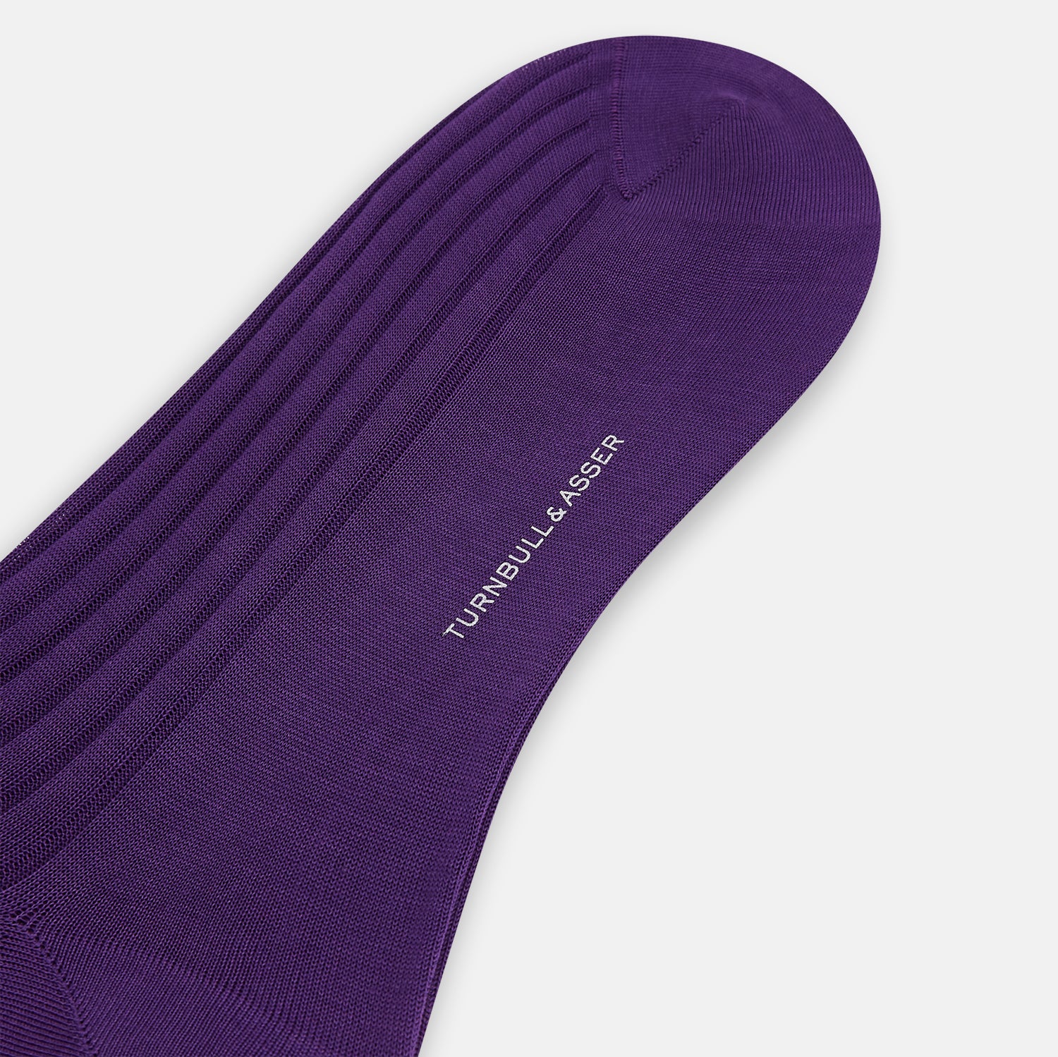 Image 3 of product A single Purple Mid-Length Sock by Turnbull & Asser stands upright against a white background, highlighting its refined ribbed texture in solid dark purple mercerised Egyptian cotton.