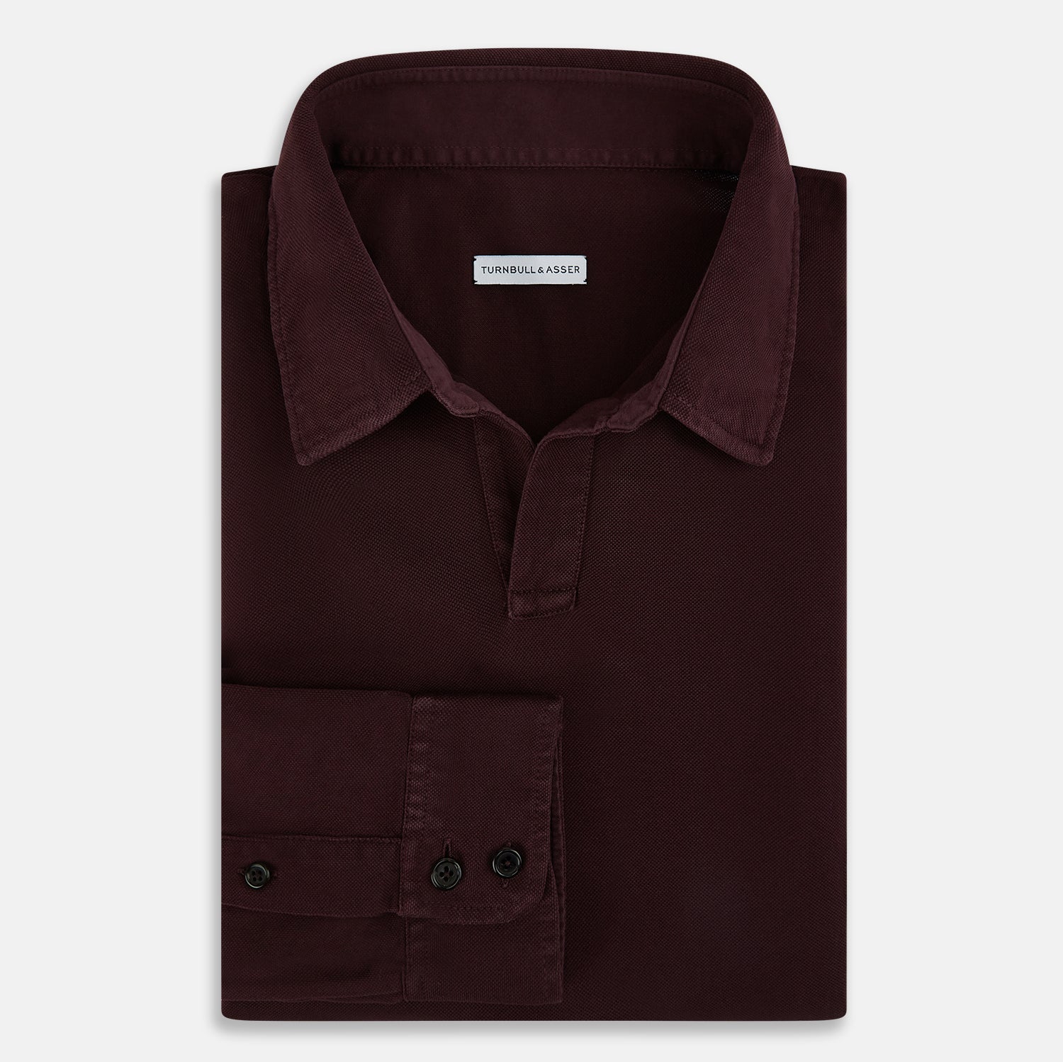 Image 5 of product The Turnbull & Asser Burgundy Rugby Polo Shirt is a long-sleeve, pure cotton collared top with no visible buttons, shown laid flat on a white background.