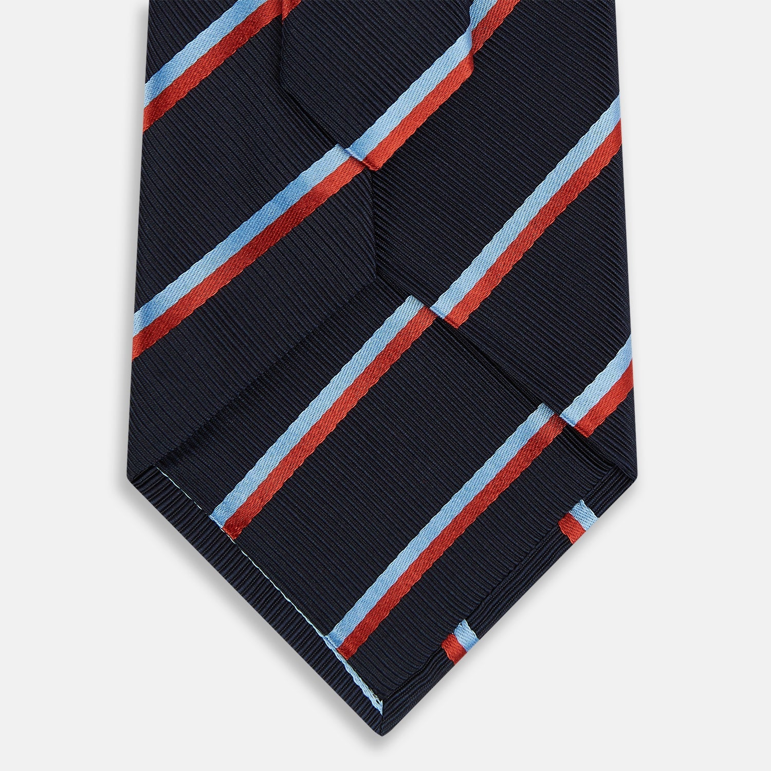Image 3 of product The Turnbull & Asser Red And Blue Stripe Silk Blend Tie, rolled on a white background, features refined diagonal accents—an elegant formal accessory.