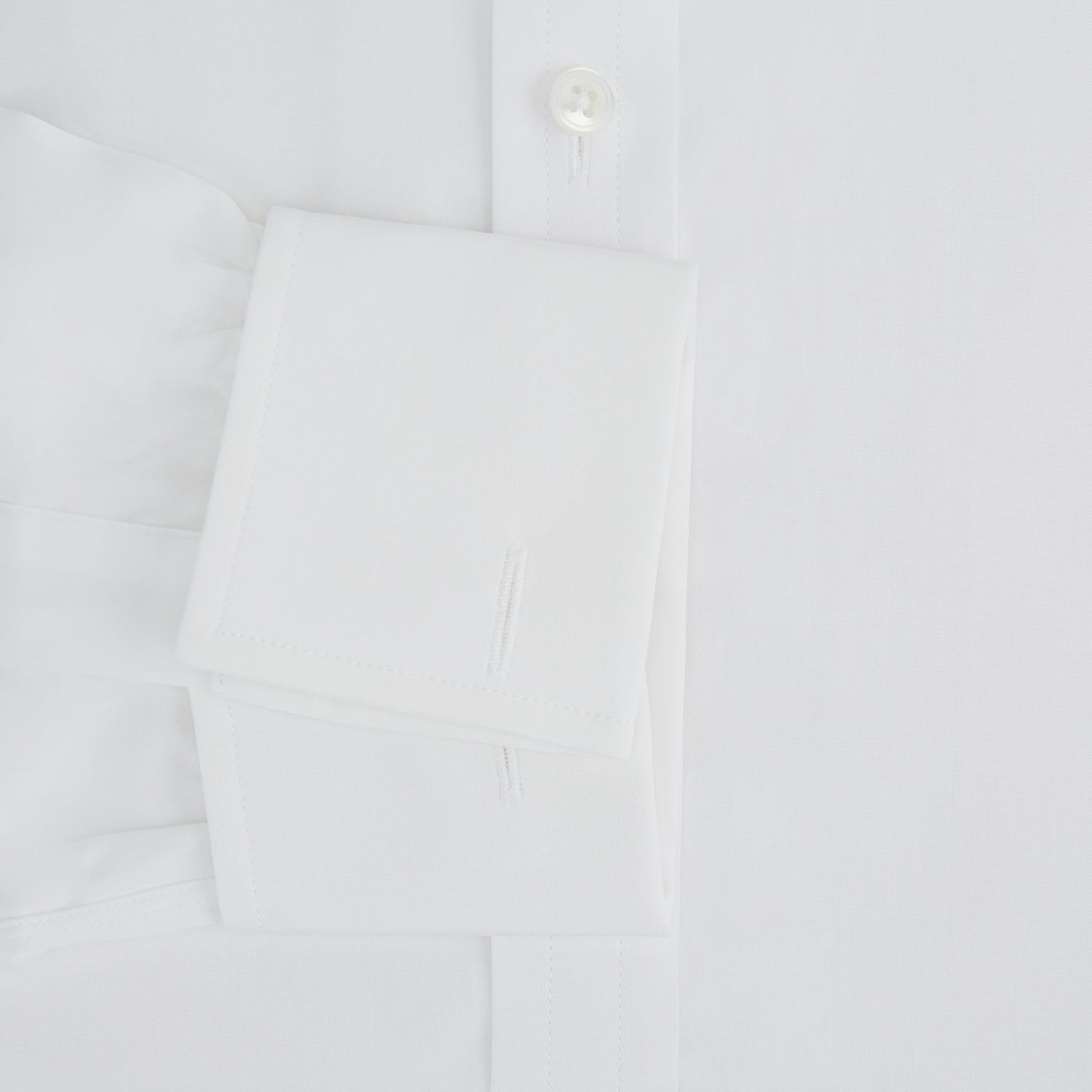 Image 3 of product The Turnbull & Asser Plain White Cotton Shirt features a T&A collar and double cuffs, shown flat on a white background—ideal for pairing with standout ties or achieving a minimalist look.