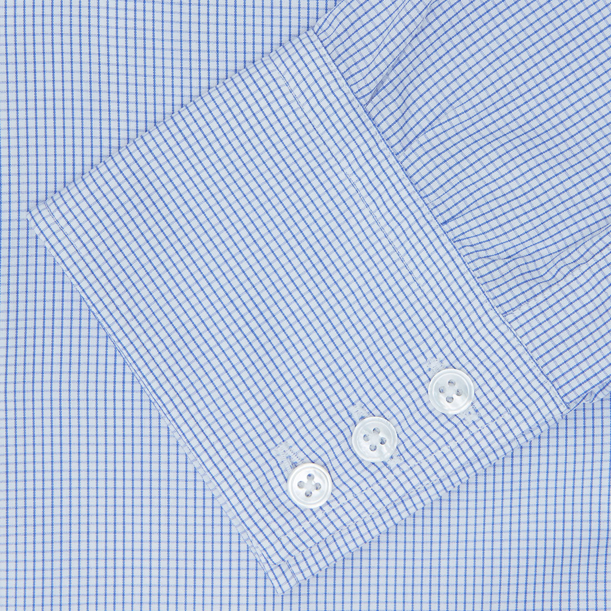 Image 3 of product A neatly folded Turnbull & Asser Blue Grid Check Shirt features a T&A collar, 3-button cuffs, white buttons, and subtle British style. The blue and white check cotton design displays the brand label inside the collar.