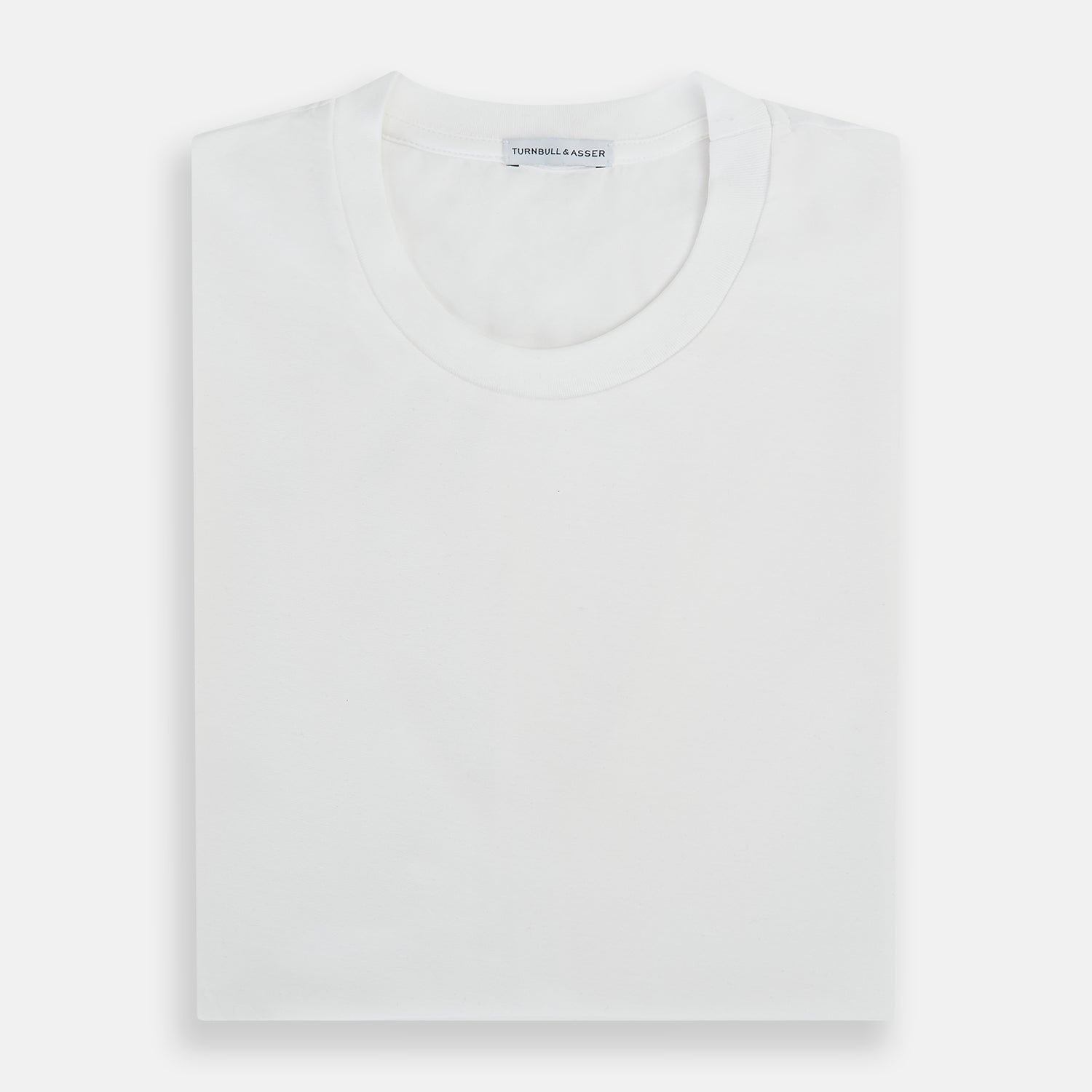Image 5 of product Experience comfort in the Turnbull & Asser White Short-sleeve Pyjama Shirt—a plain crew neck T-shirt laid flat on a white background, perfect as elevated loungewear or a sleek pyjama essential.