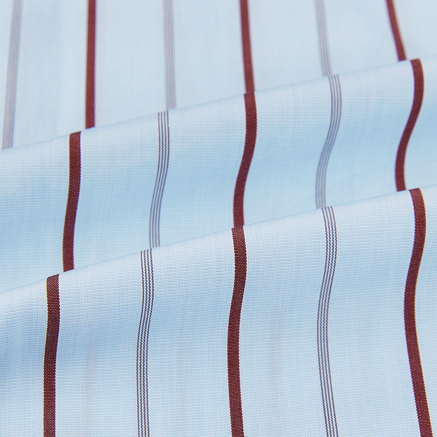 Image 6 of product The Turnbull & Asser Burgundy Wide Pinstripe Mayfair Shirt features a collared, long-sleeve design with bold vertical stripes, crafted in the refined Mayfair fit and displayed on a plain white background.