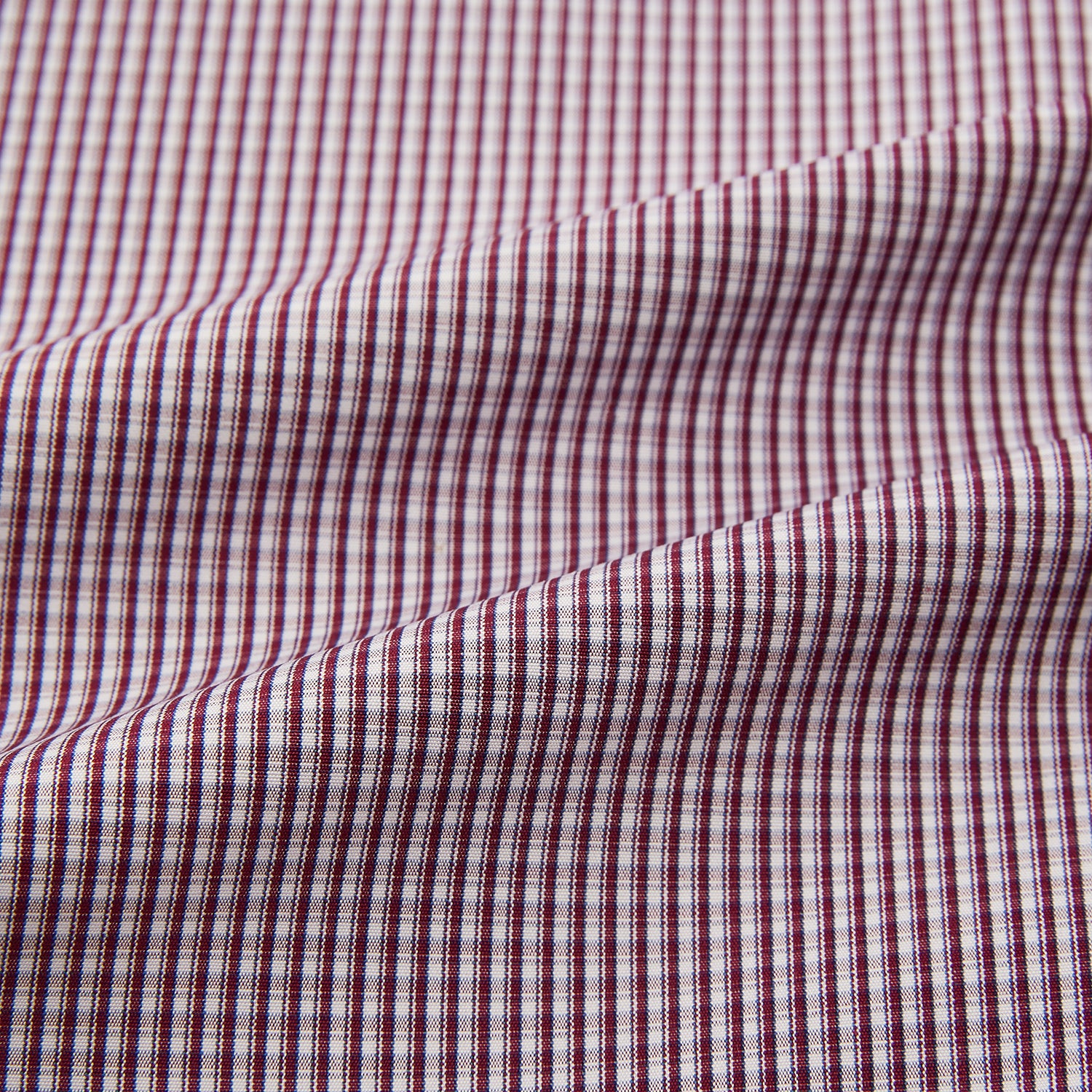 Image 6 of product The Turnbull & Asser Burgundy Micro Check Mayfair Shirt features long sleeves, a pointed collar, and white buttons—perfect for formal wear. Shown laid flat on a white background.