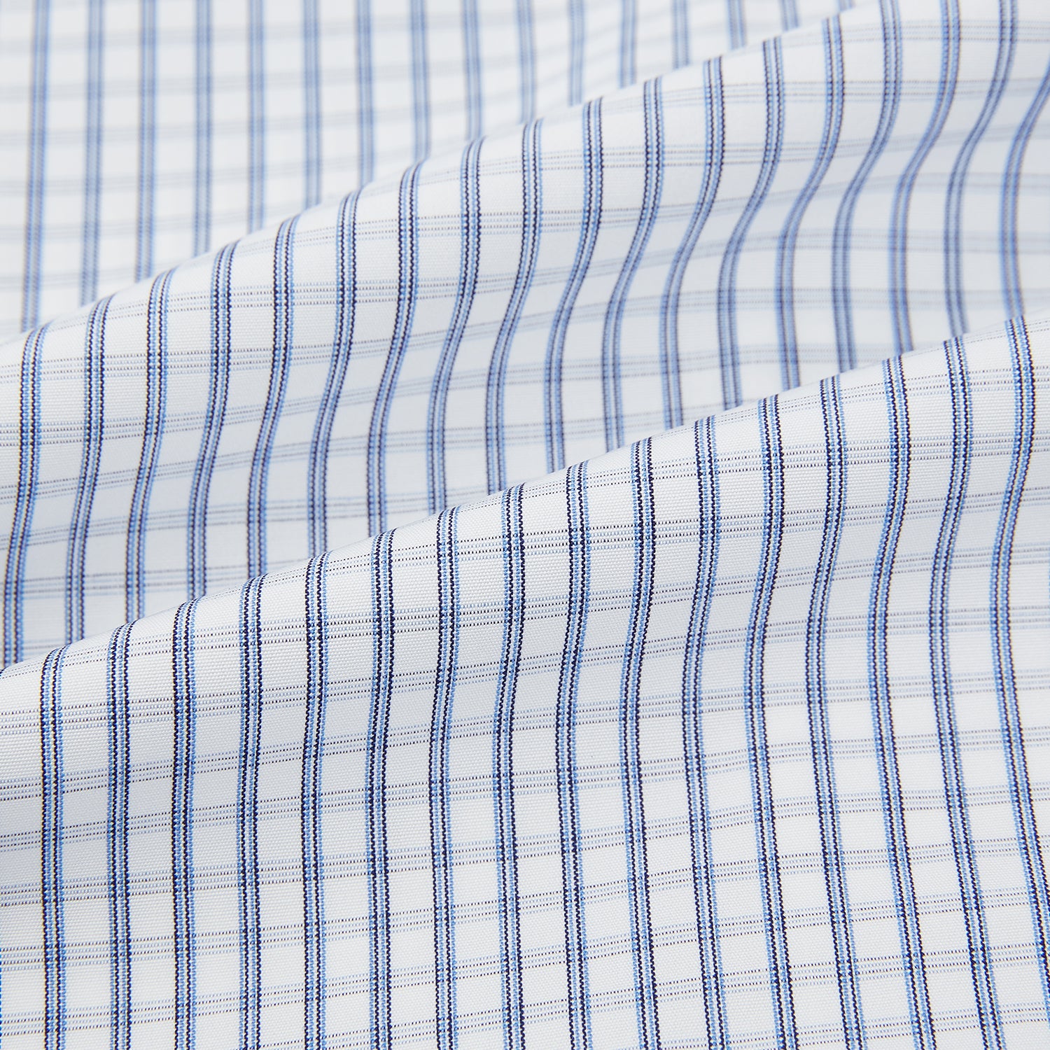 Image 6 of product The Turnbull & Asser Blue Multi Tattersall Check Mayfair Shirt is a long-sleeved, button-down shirt featuring a small blue and white check pattern, pointed collar, and cuffs, shown laid flat on a white background.