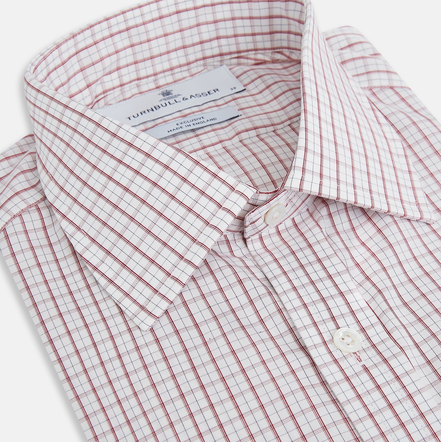 Image 2 of product The Turnbull & Asser Red Tattersall Check Mayfair Shirt features long sleeves, a collar, and Italian cotton with a red tattersall check on white, shown flat against a white background.