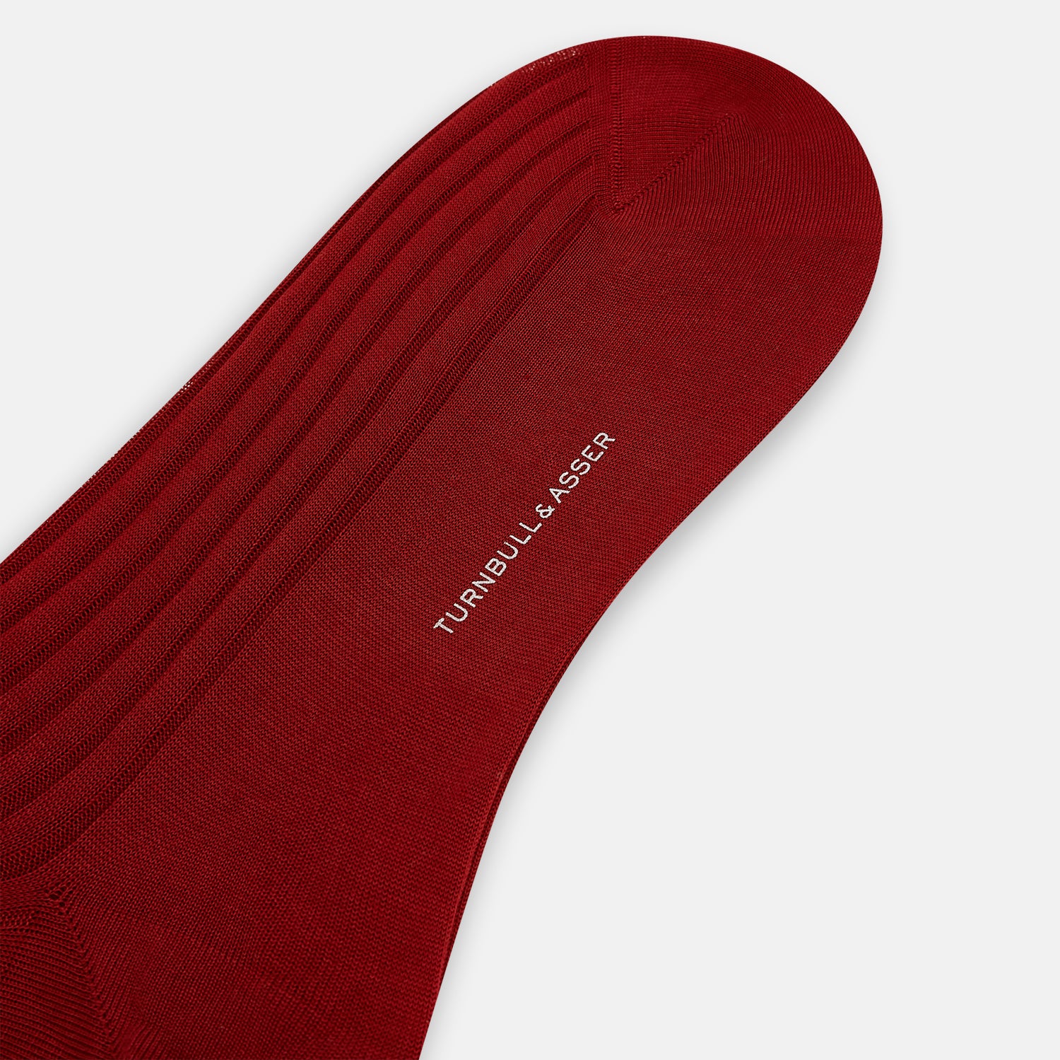 Image 3 of product Turnbull & Asser’s Wine Mid-Length Sock, crafted from mercerised Egyptian cotton with a ribbed texture, is displayed upright on a light gray background, highlighting its refined comfort and dark red hue.