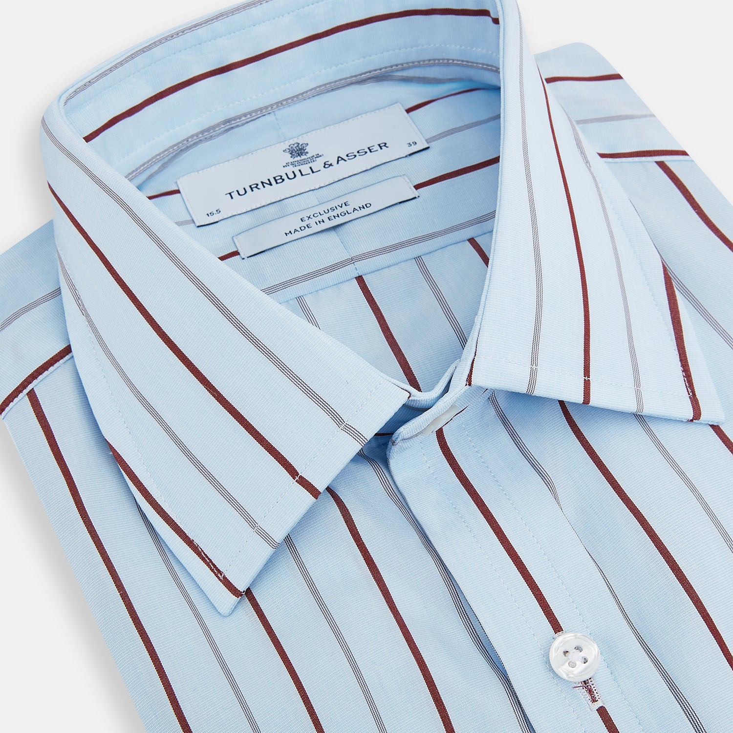 Image 2 of product The Turnbull & Asser Burgundy Wide Pinstripe Mayfair Shirt features a collared, long-sleeve design with bold vertical stripes, crafted in the refined Mayfair fit and displayed on a plain white background.