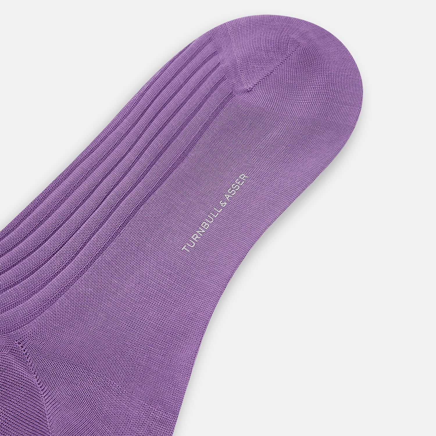 Image 3 of product A single Violet Mid-Length Sock by Turnbull & Asser, made from ribbed mercerised Egyptian cotton, is displayed side-on with the toe pointing left against a plain light background.