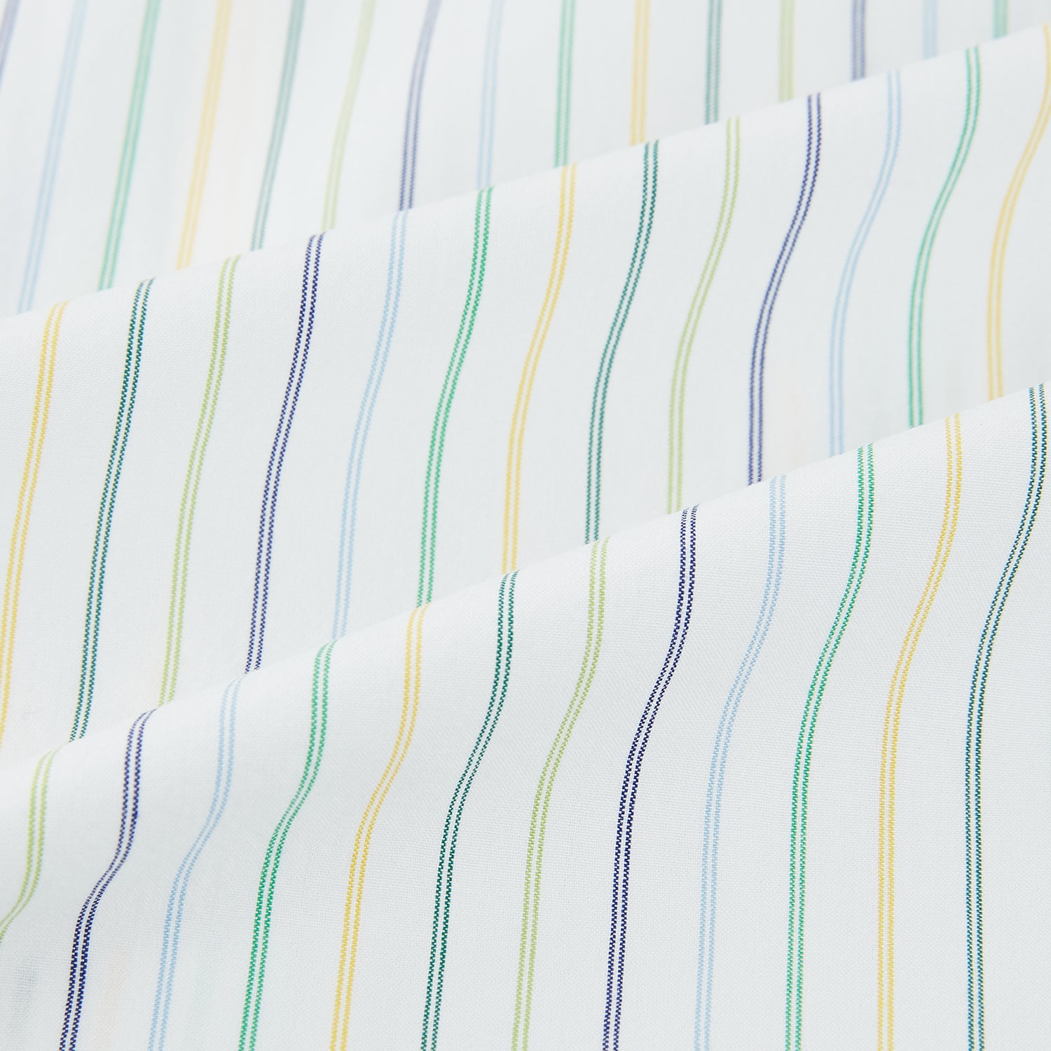 Image 6 of product The Turnbull & Asser Multi Tone Double Pinstripe Mayfair Shirt is a long-sleeve pure cotton shirt with a collar and thin blue, green, and yellow double pinstripes on a white background.
