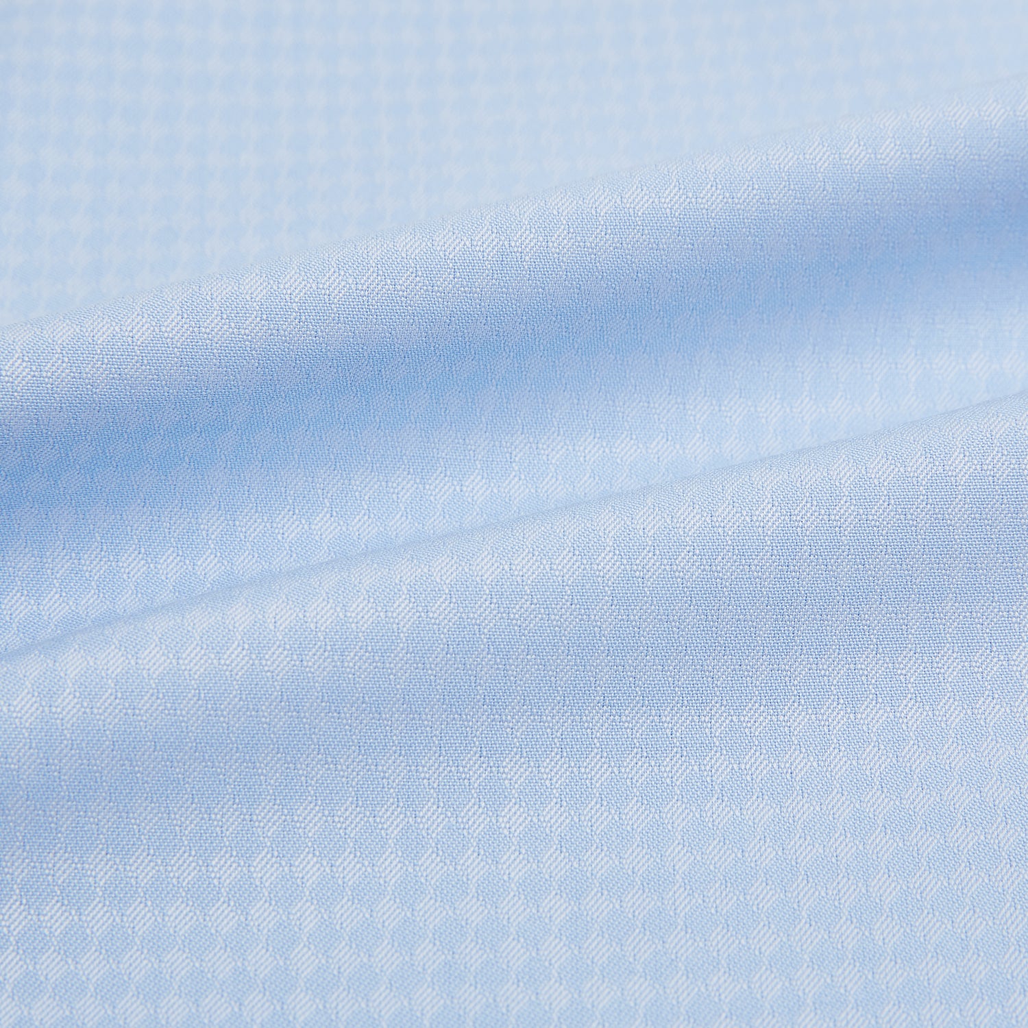 Image 6 of product The Pale Blue Rhombus Mayfair Shirt by Turnbull & Asser features long sleeves, a classic collar, white buttons, and buttoned cuffs, shown laid flat on a white background.